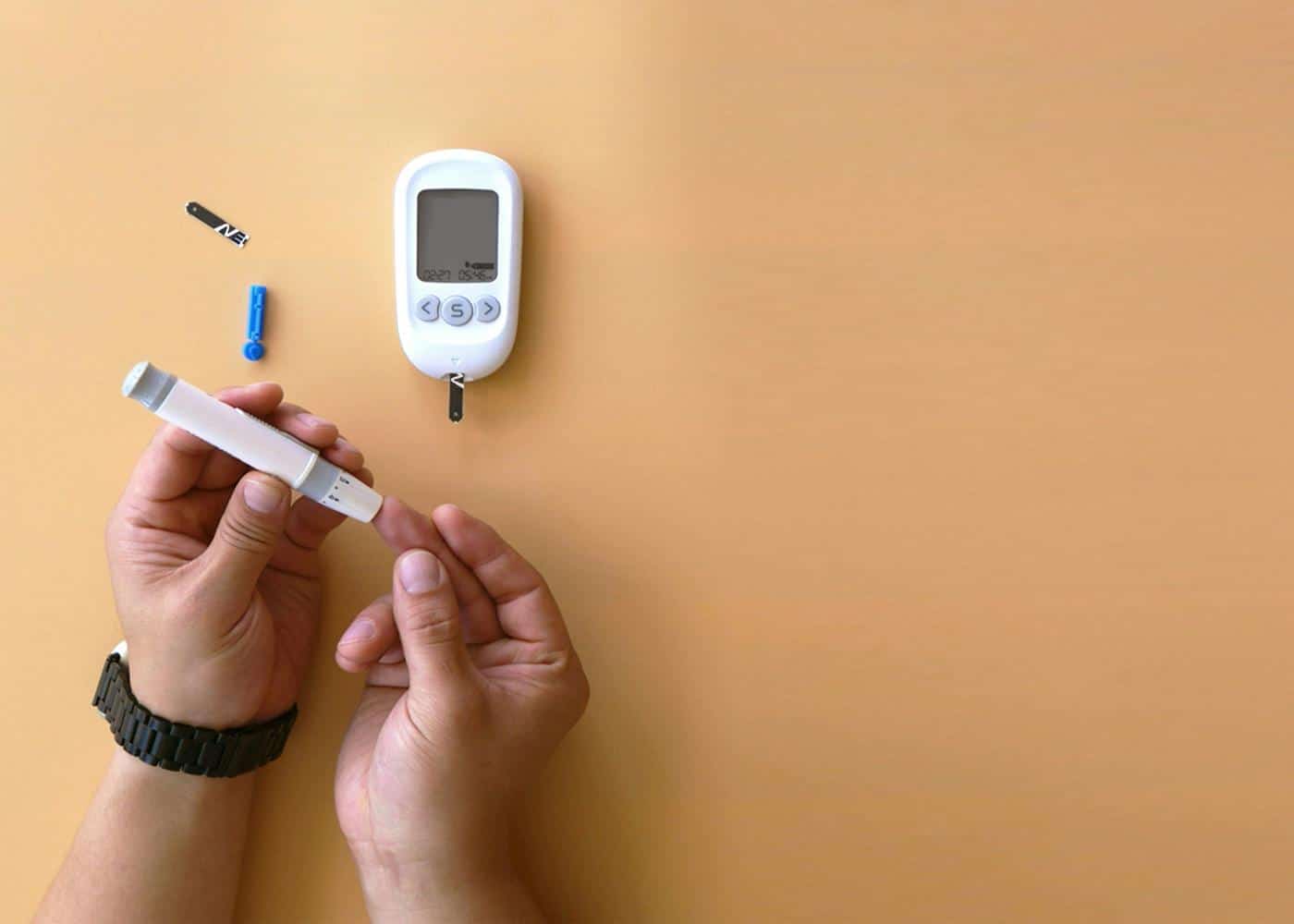 Person using a blood glucose monitoring machine