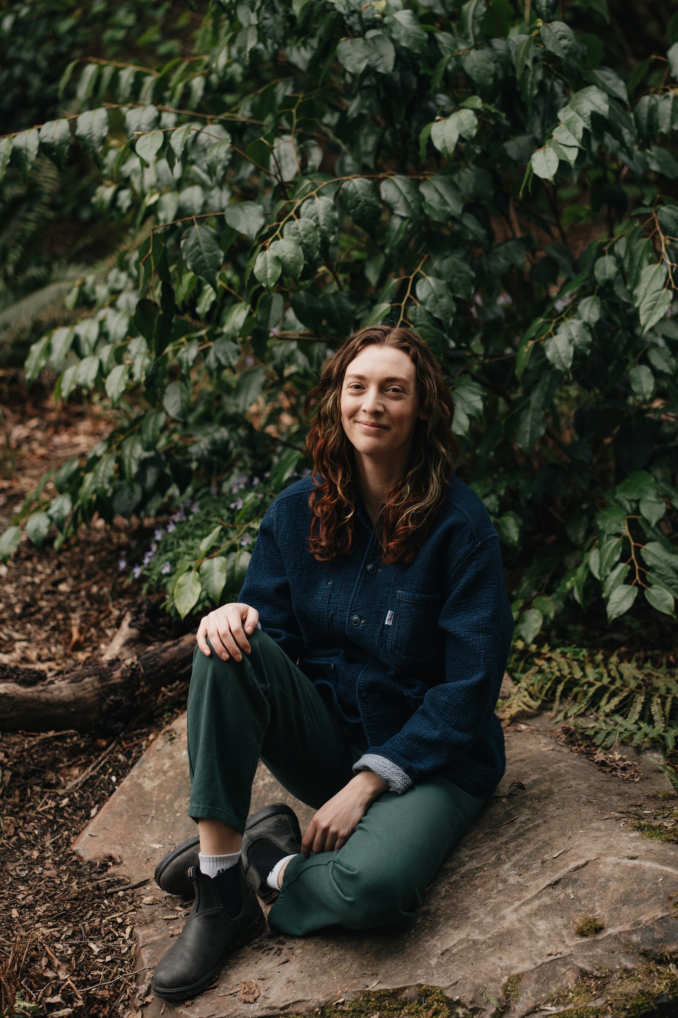 Amy smiling infront of a waterfall in the forest