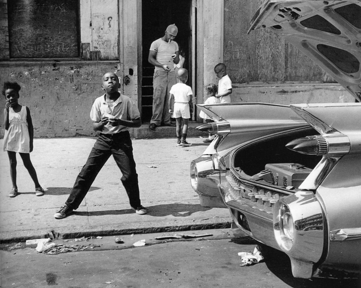 Black-and-white street scene of children beside a classic car, from Everlast's 'Nothing soft comes out of The Bronx'