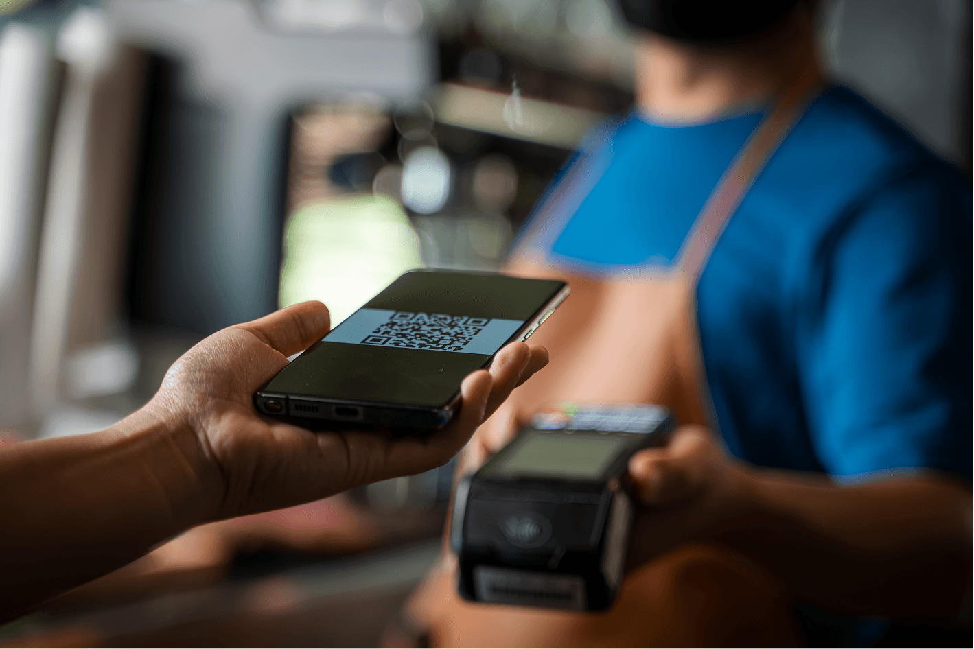 Image of a customer making a digital payment using a smartphone in a finance and insurance video.