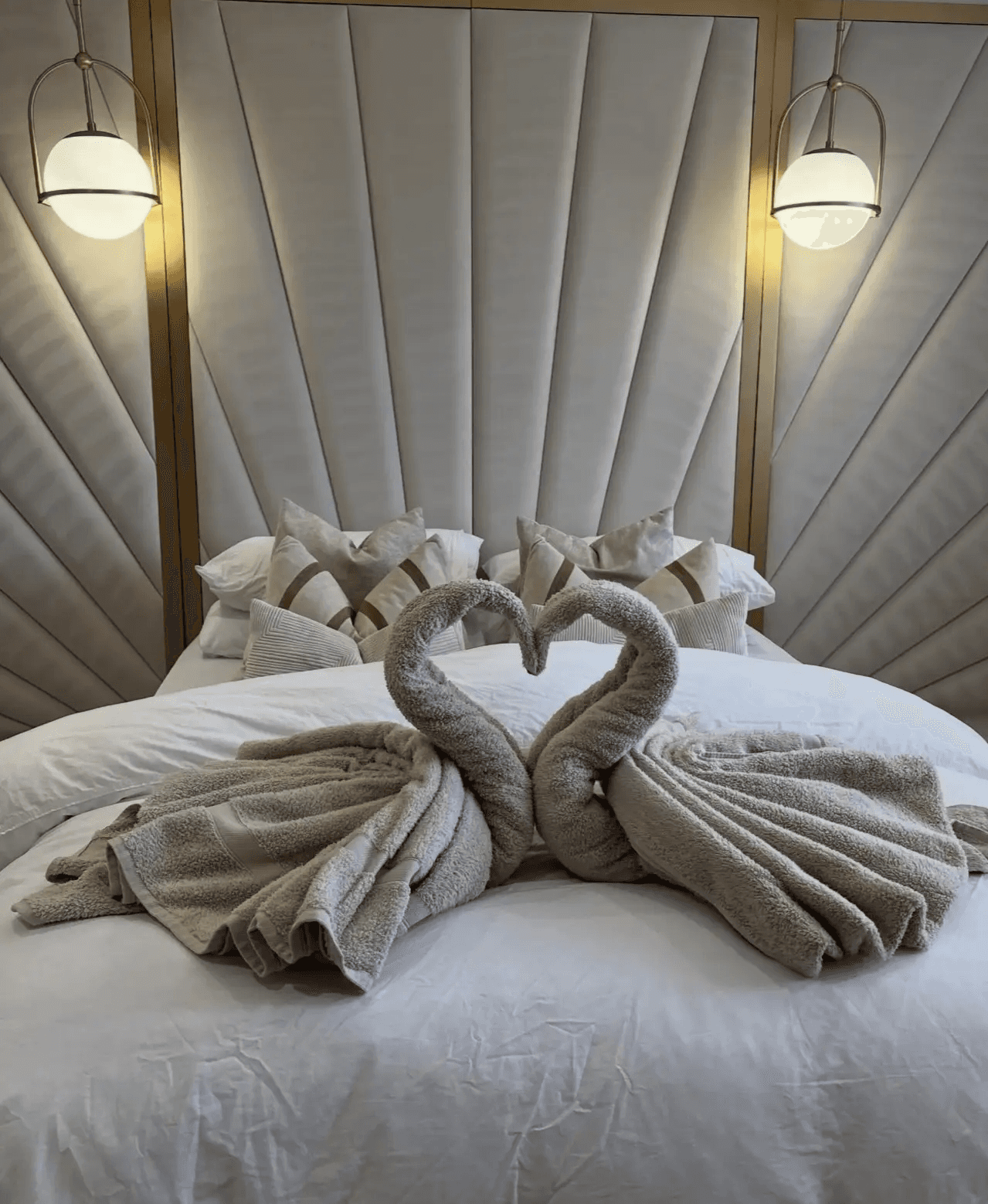 Elegant towel swans on a master bed, displaying the boutique-level service and care given to every Chandler, AZ house cleaning client.