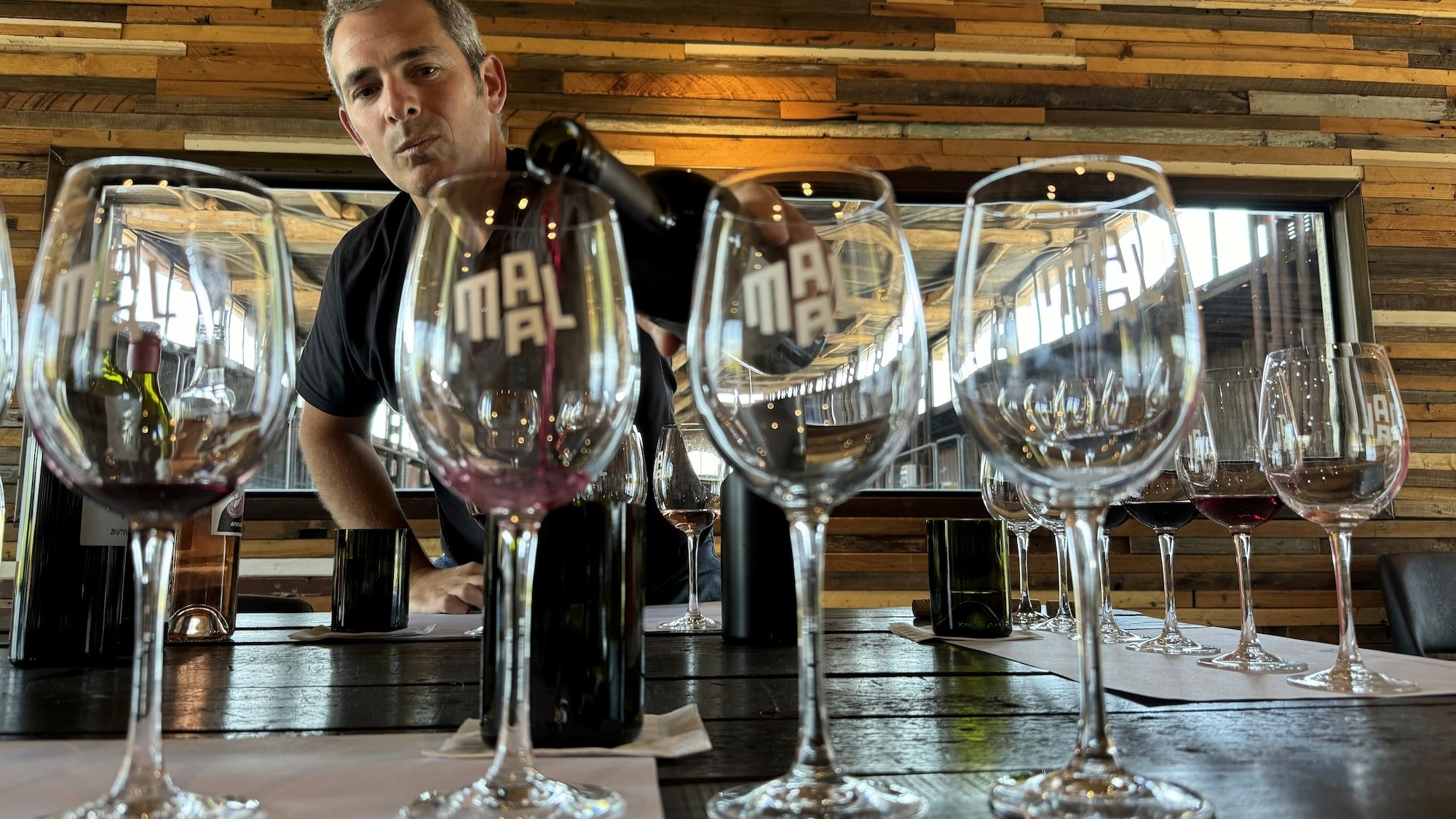 MAAL cofounder Matías Fraga pouring Malbec during a tasting in the winery’s Luján de Cuyo tasting room