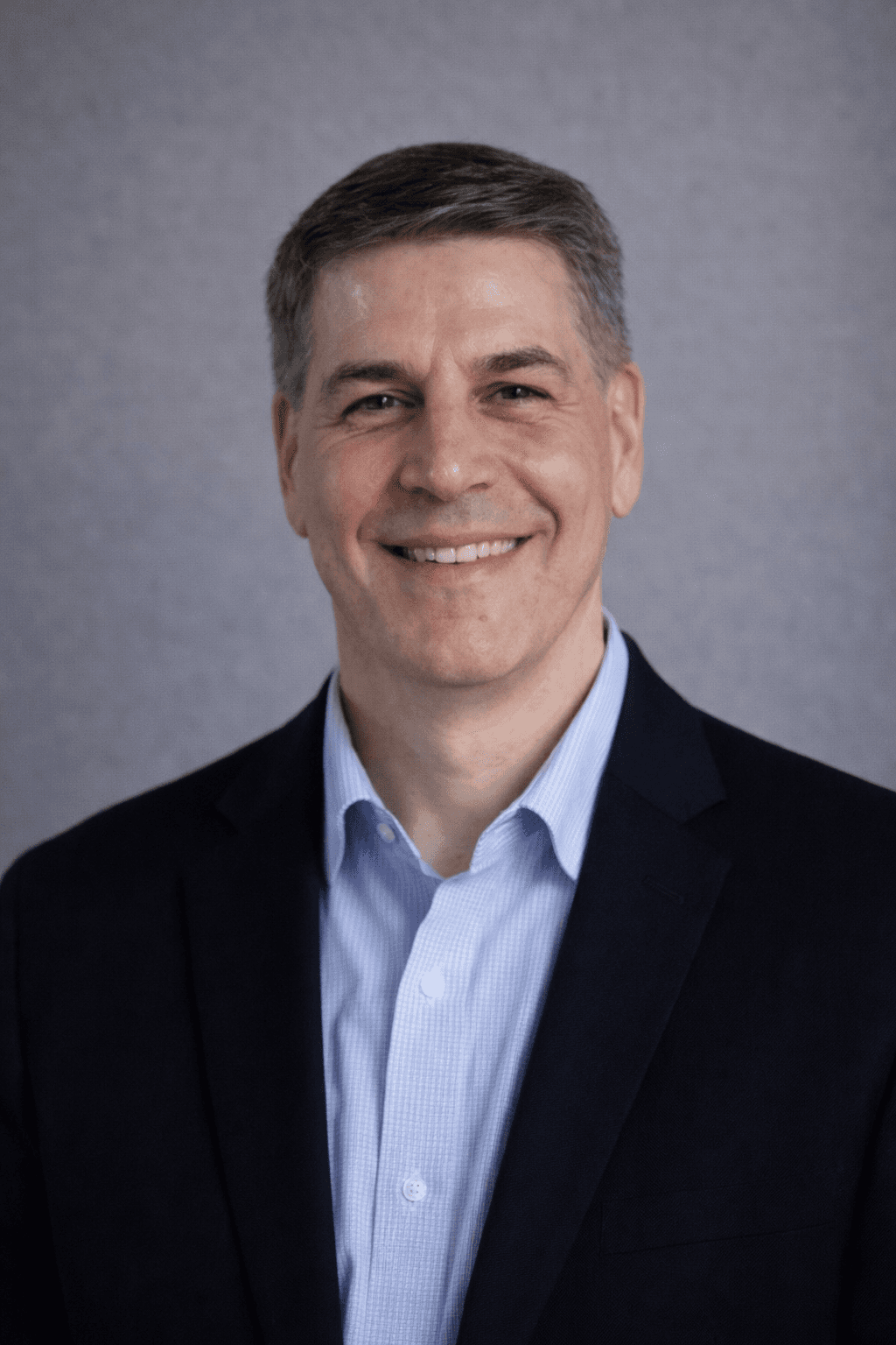 Black and white portrait of a smiling person with curly hair