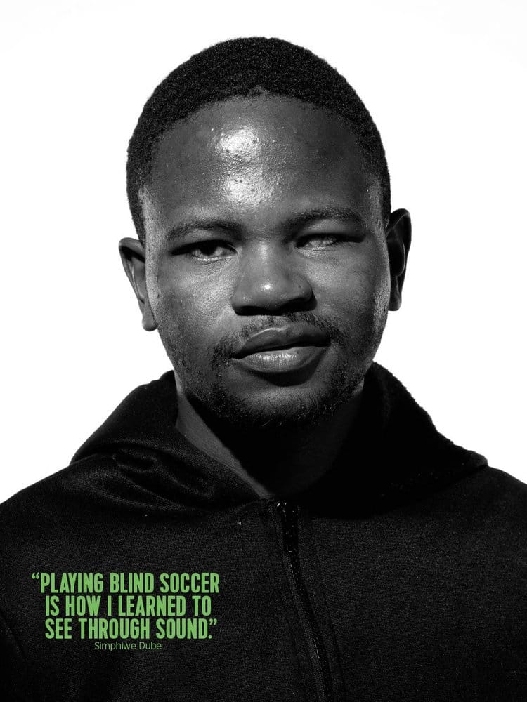 a man in a red shirt holding two fingers up