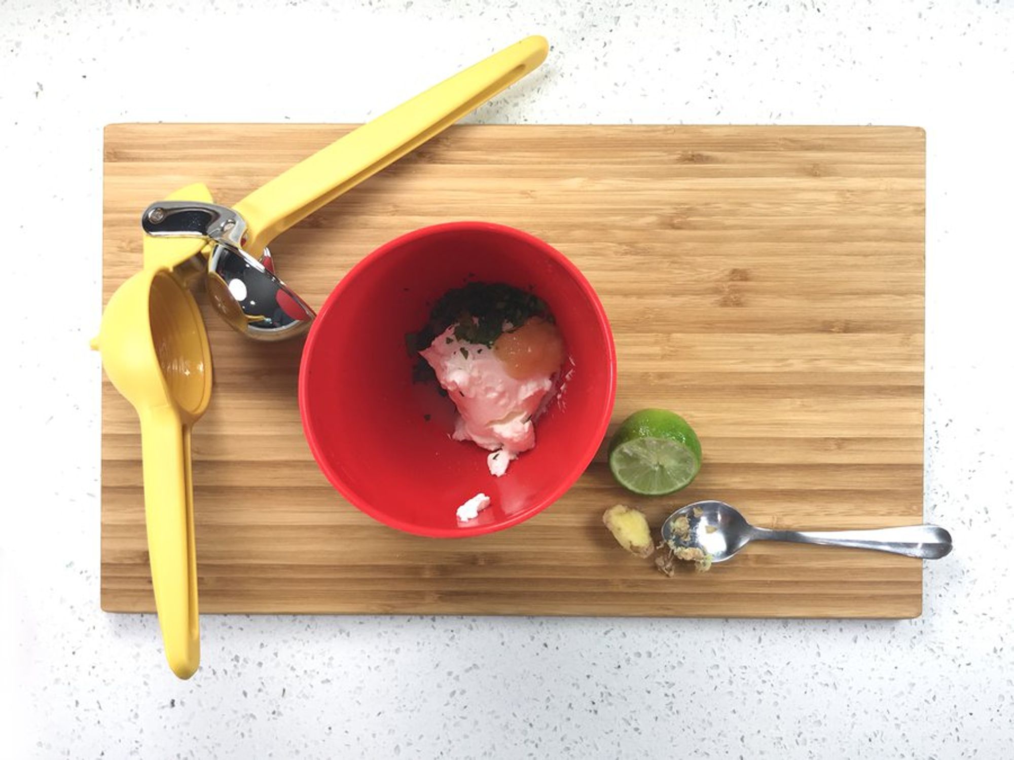 coconut cream, lime juice, zest, ginger and garlic ready to be whisked in a bowl