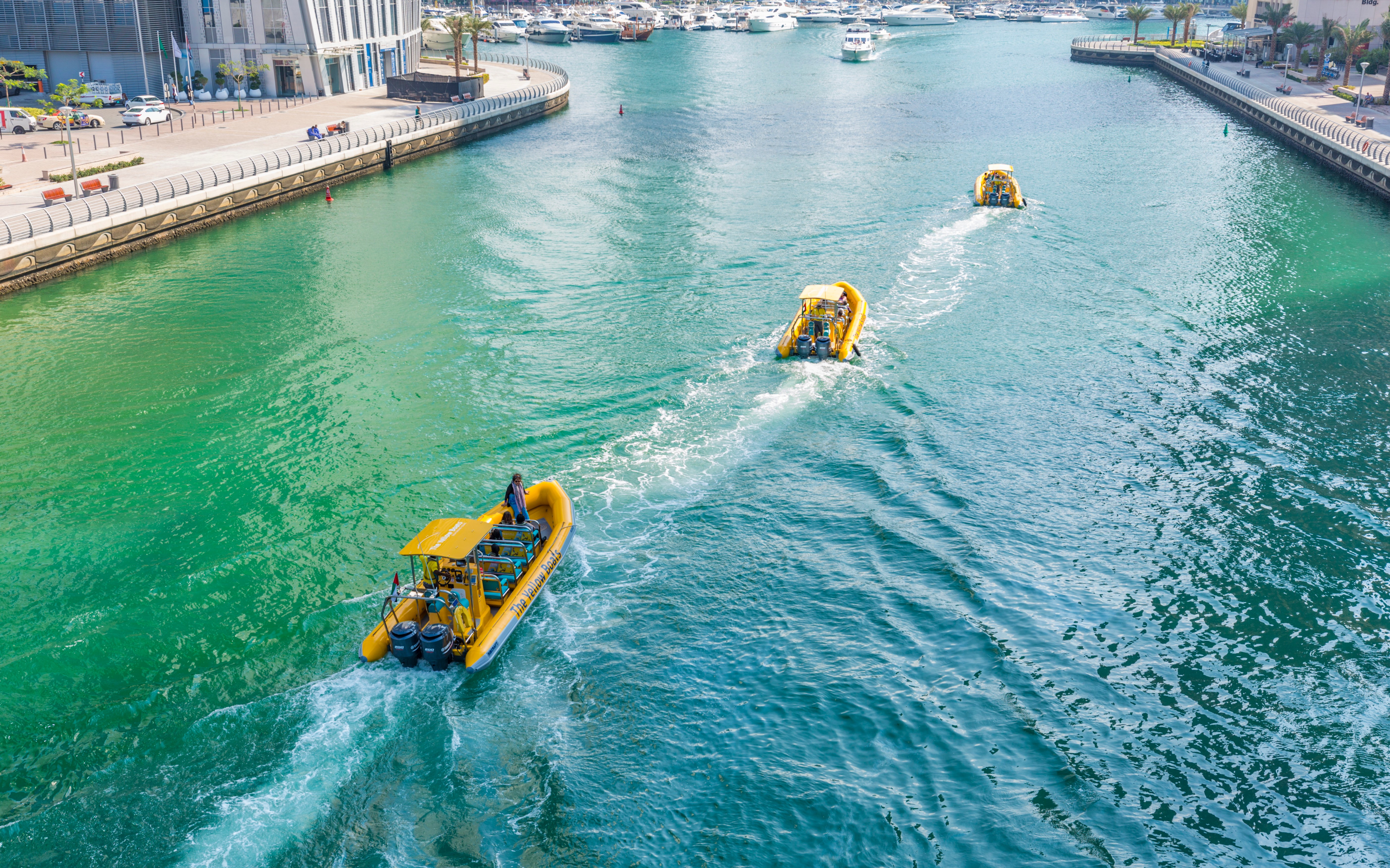 Speedboat cruising past Dubai Marina skyscrapers on a guided tour.