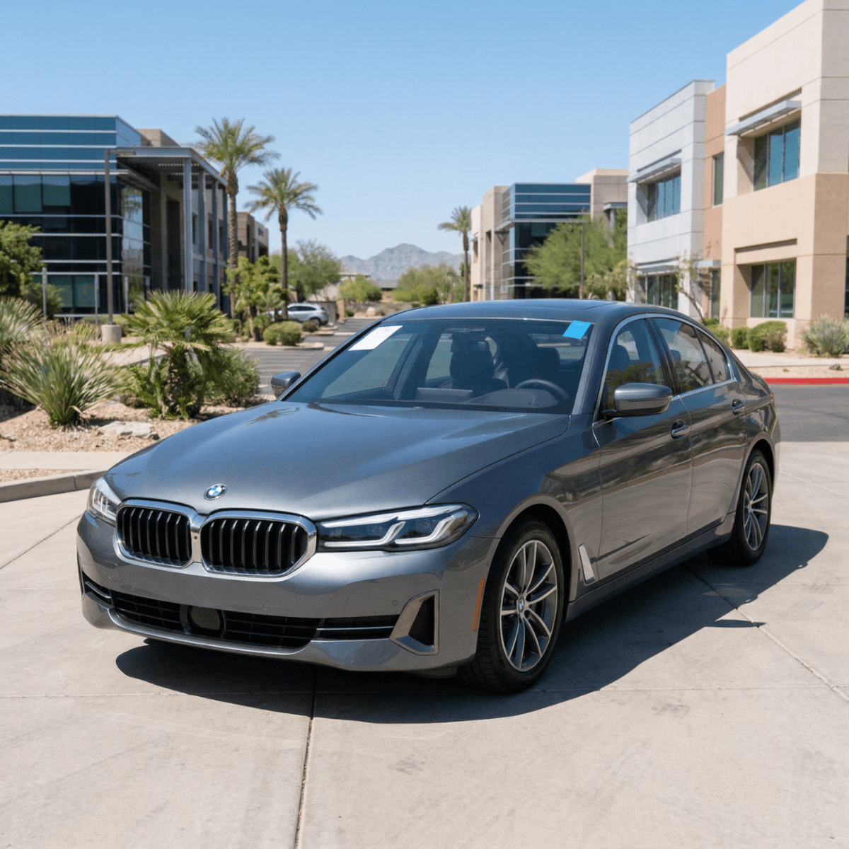 Silver BMW 5 Series with a pristine new windshield outside a Scottsdale, AZ residential community