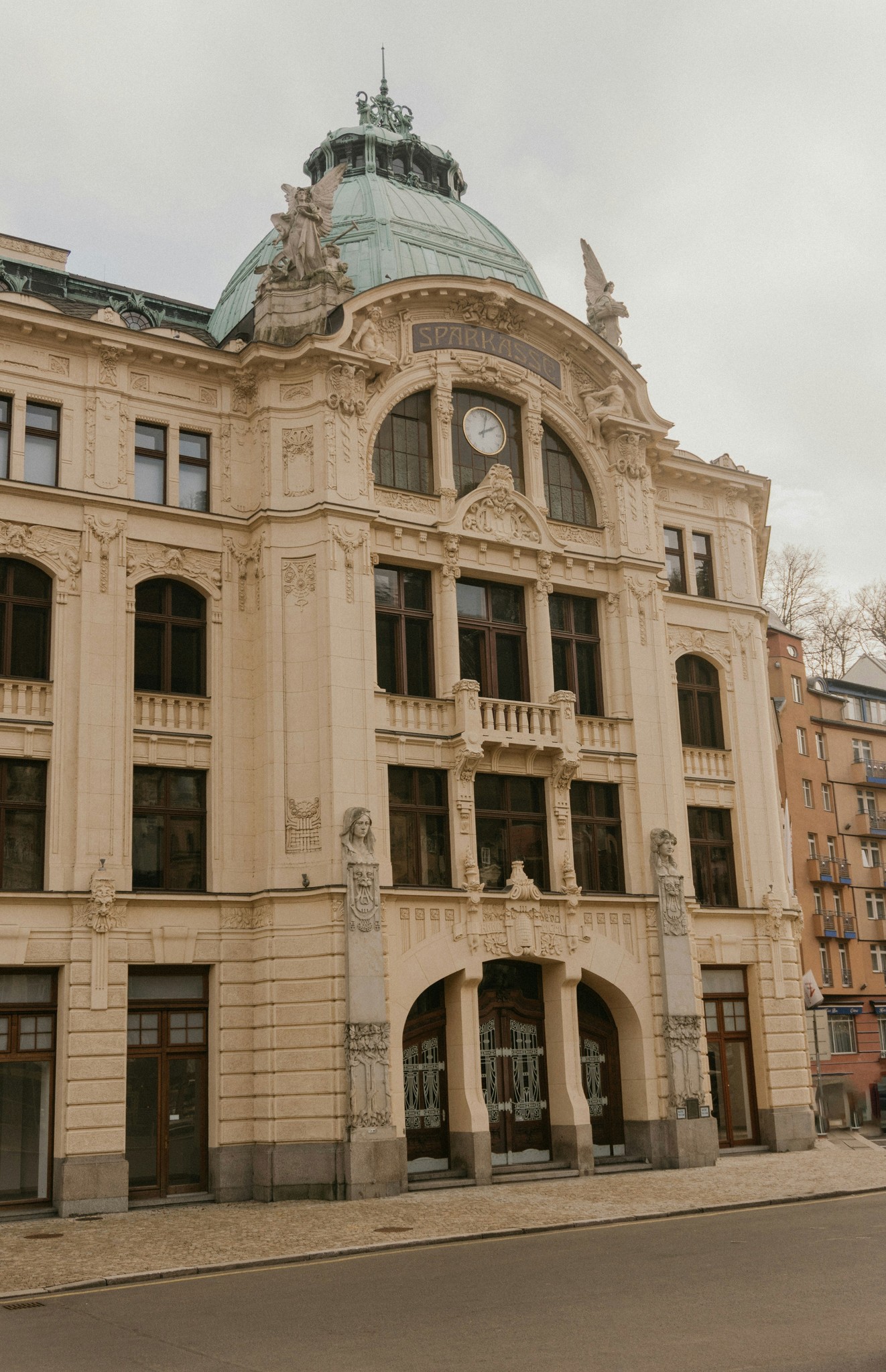 Ornate building with a green dome and clock