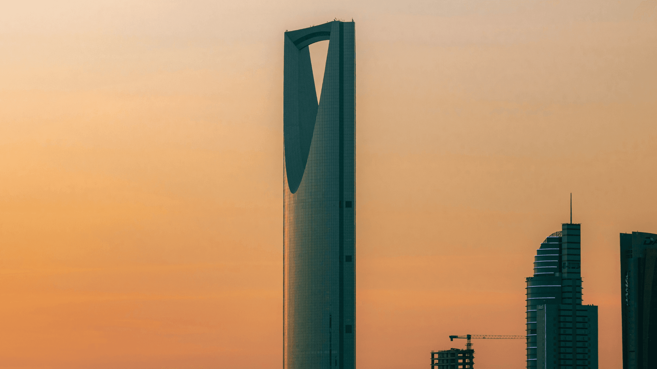 Saudi Arabian skyline at sunset, representing the digital identity infrastructure behind instant KYC in the KSA.