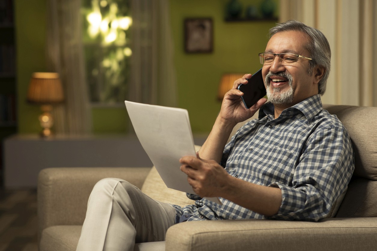 Man on phone holding direct mail