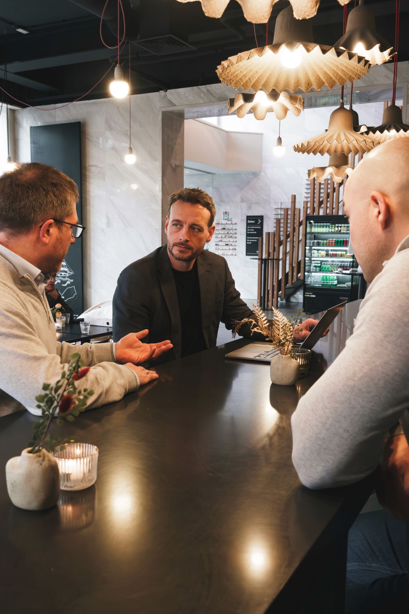 Person typing on laptop with data charts on screen