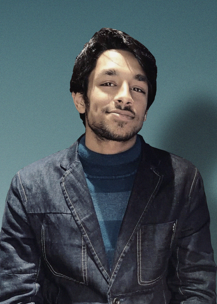 Smiling young man with curly hair, wearing a dark hoodie, against a softly lit background.