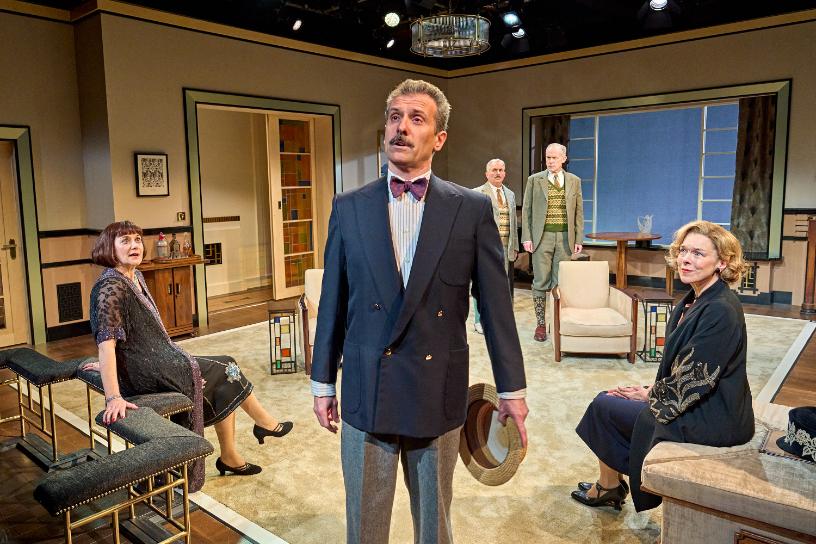 Cast gathered in a vintage living room during a dramatic moment in Fallen Angels.