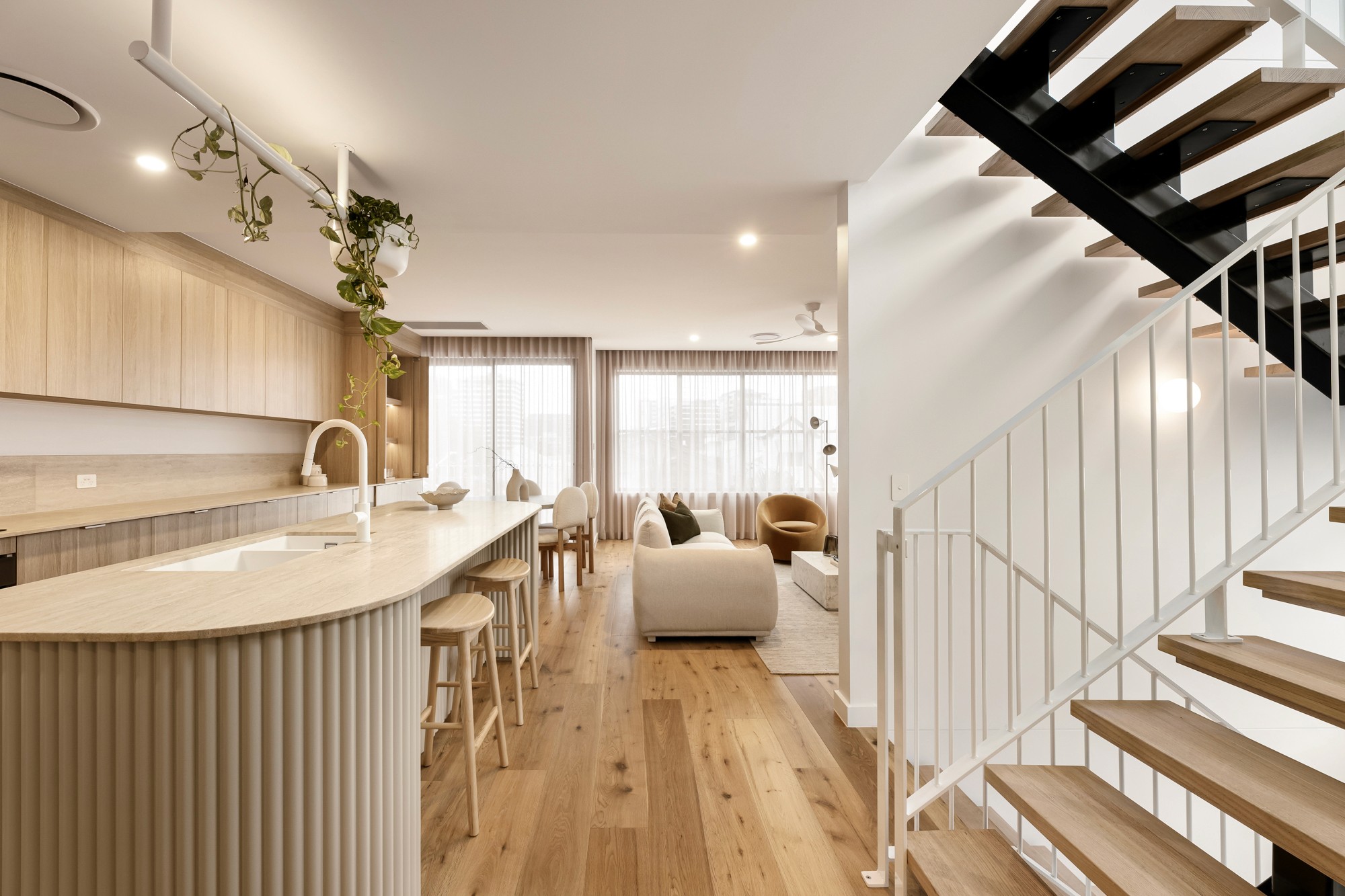 Staircase with light timber treads and a vertical timber balustrade.