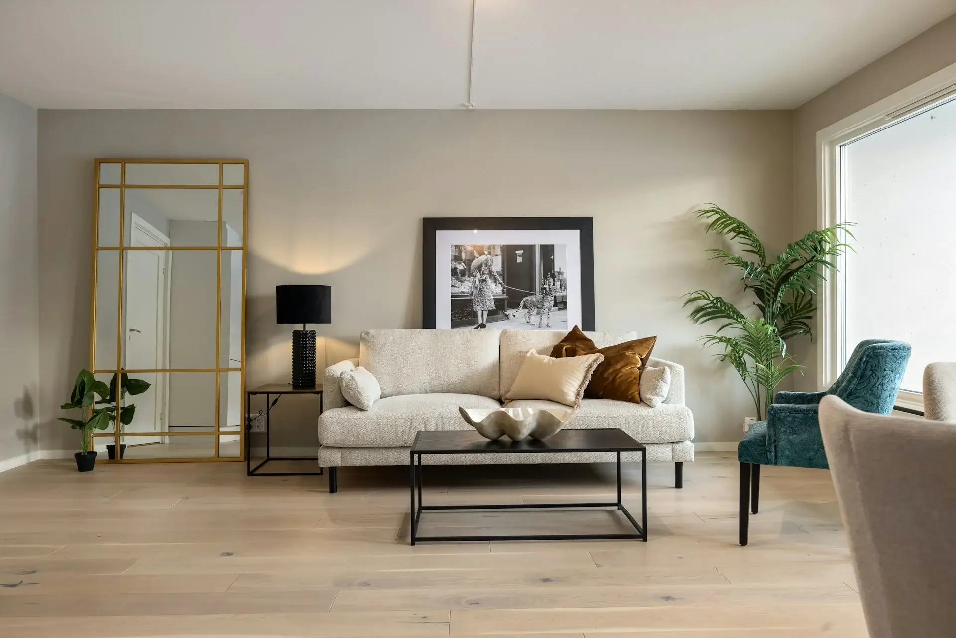 Cozy living room with gray sectional sofa, warm floor lamp, and minimal decor.