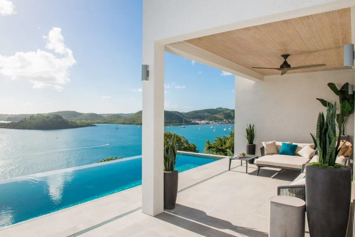 Covered terrace with infinity pool and panoramic Caribbean sea views at Calivigny Point resort in Grenada