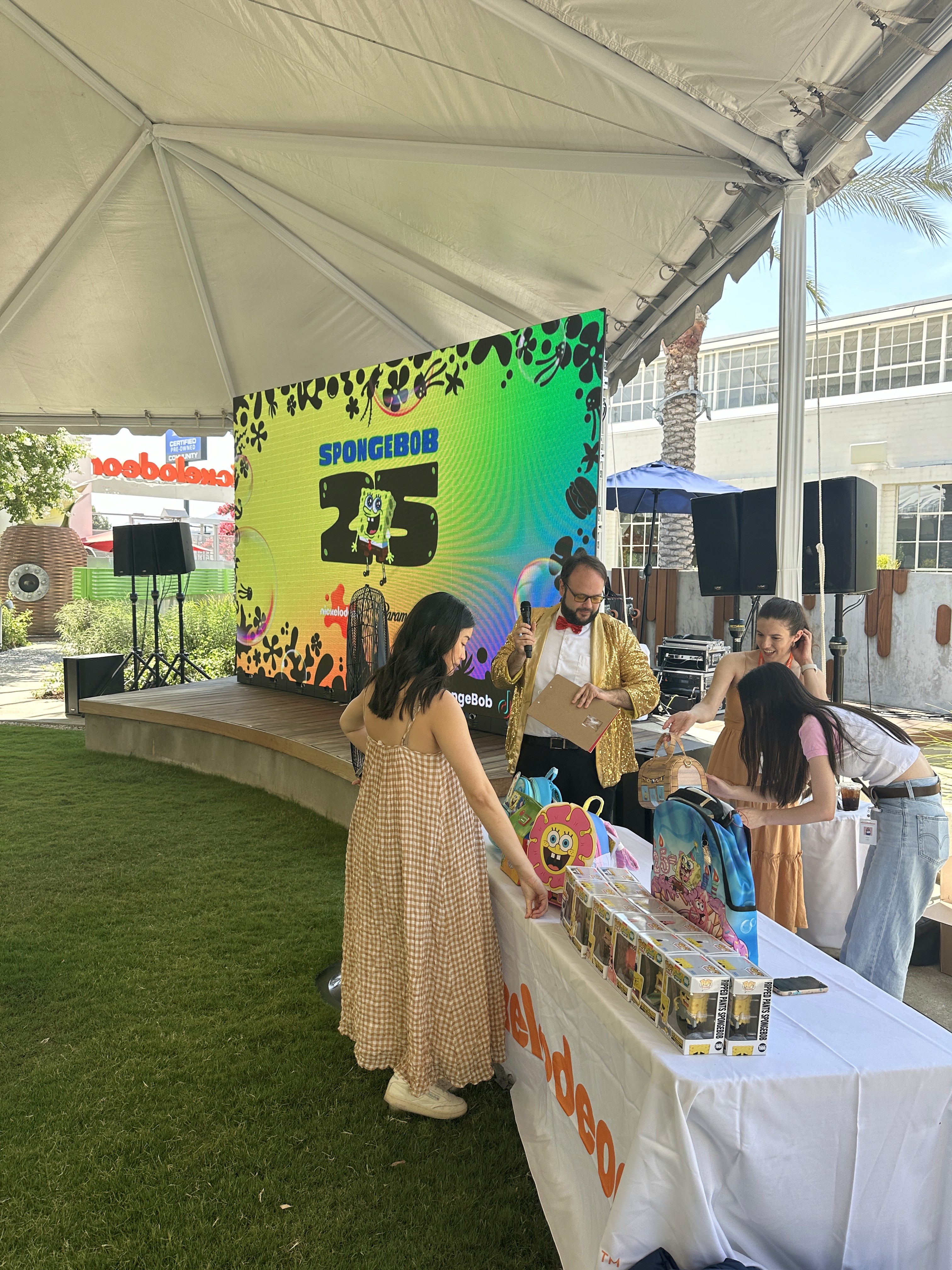 Attendees watching a presentation on-screen during the Nickelodeon brand anniversary celebration.