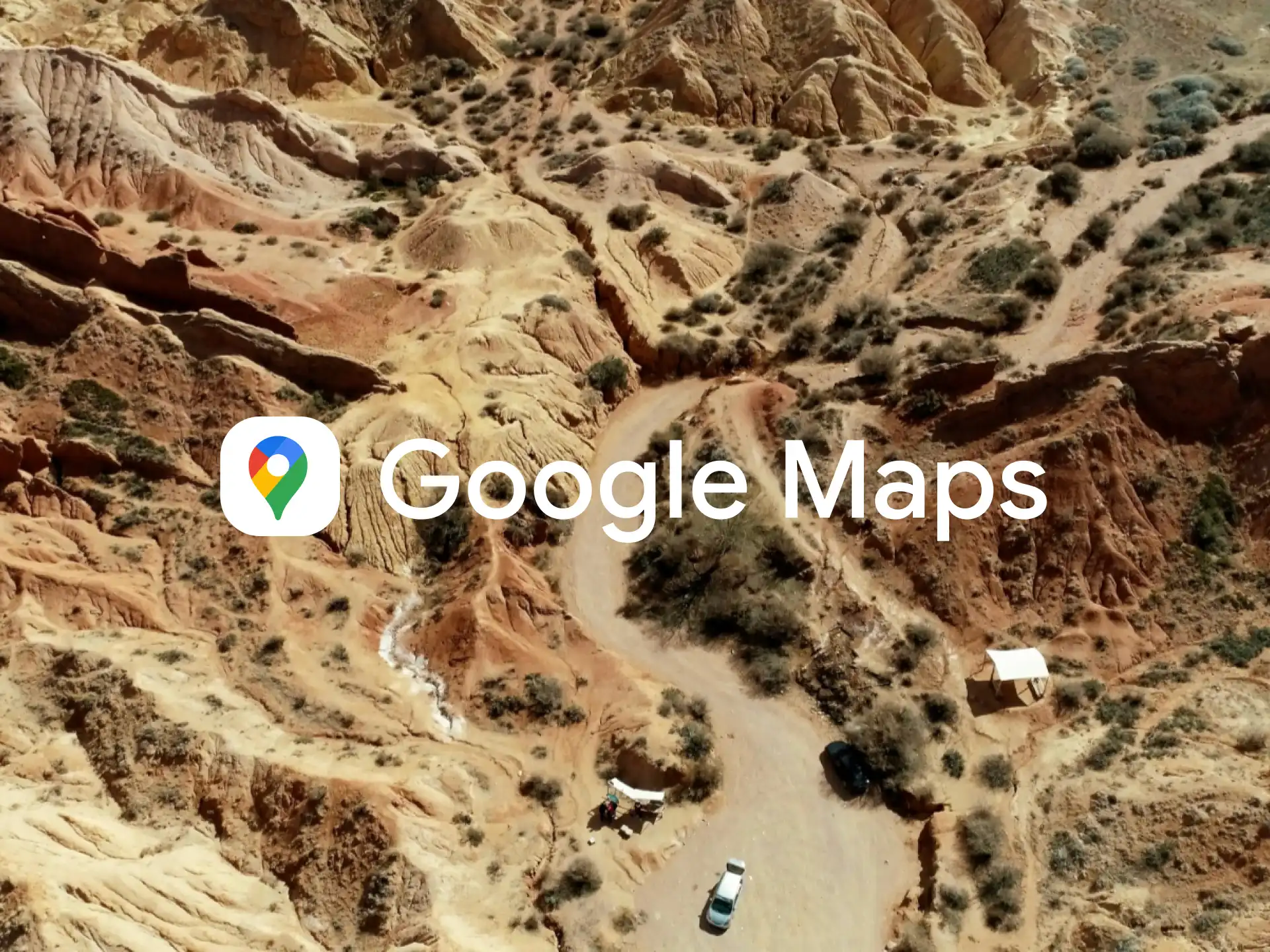 an aerial view of a road in the mountains