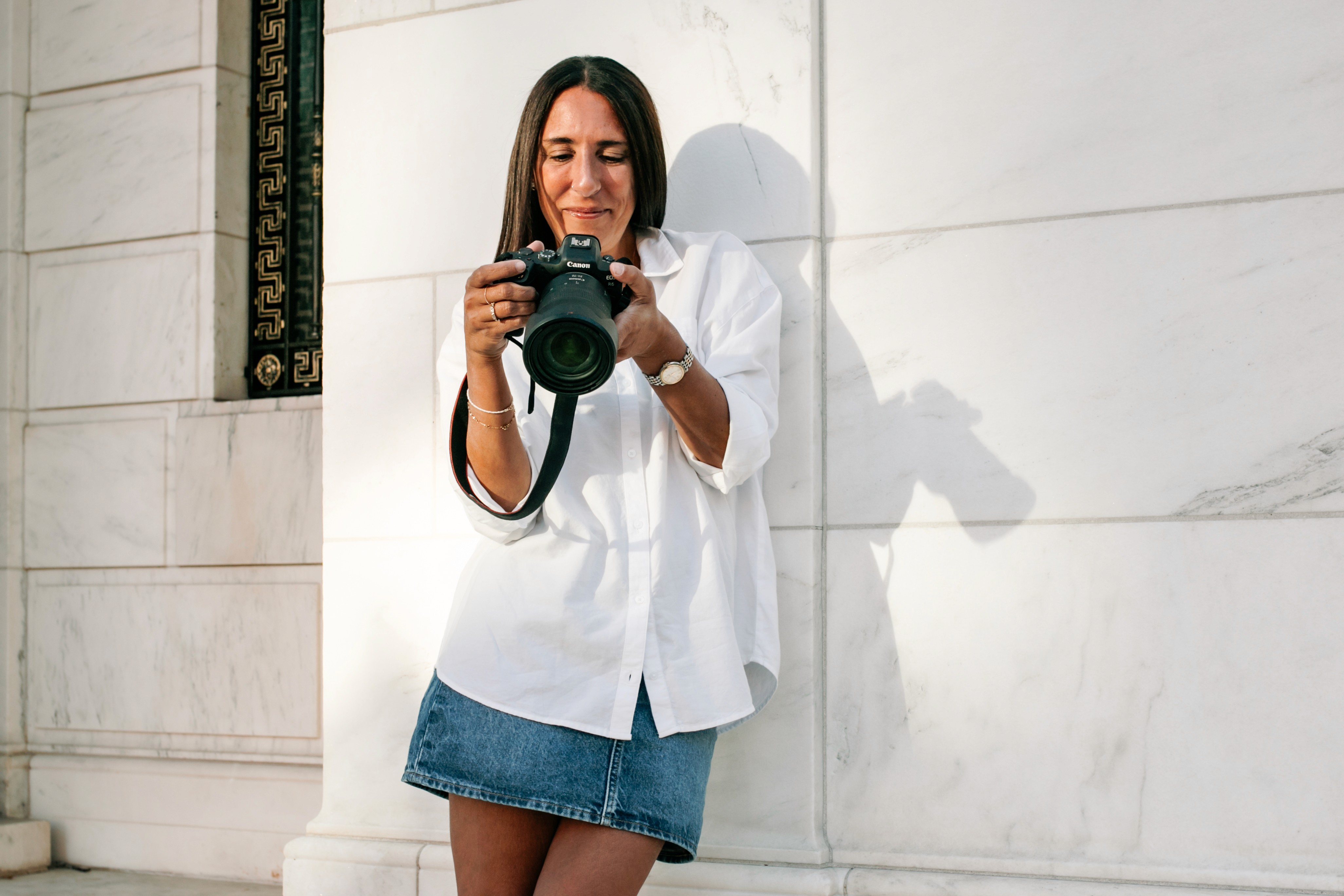 5:05 PMLizz Spano, New York City photographer, walking and smiling through her neighborhood of Gramercy Park, camera in hand — a candid glimpse into the woman behind Lizz Spano Photography.