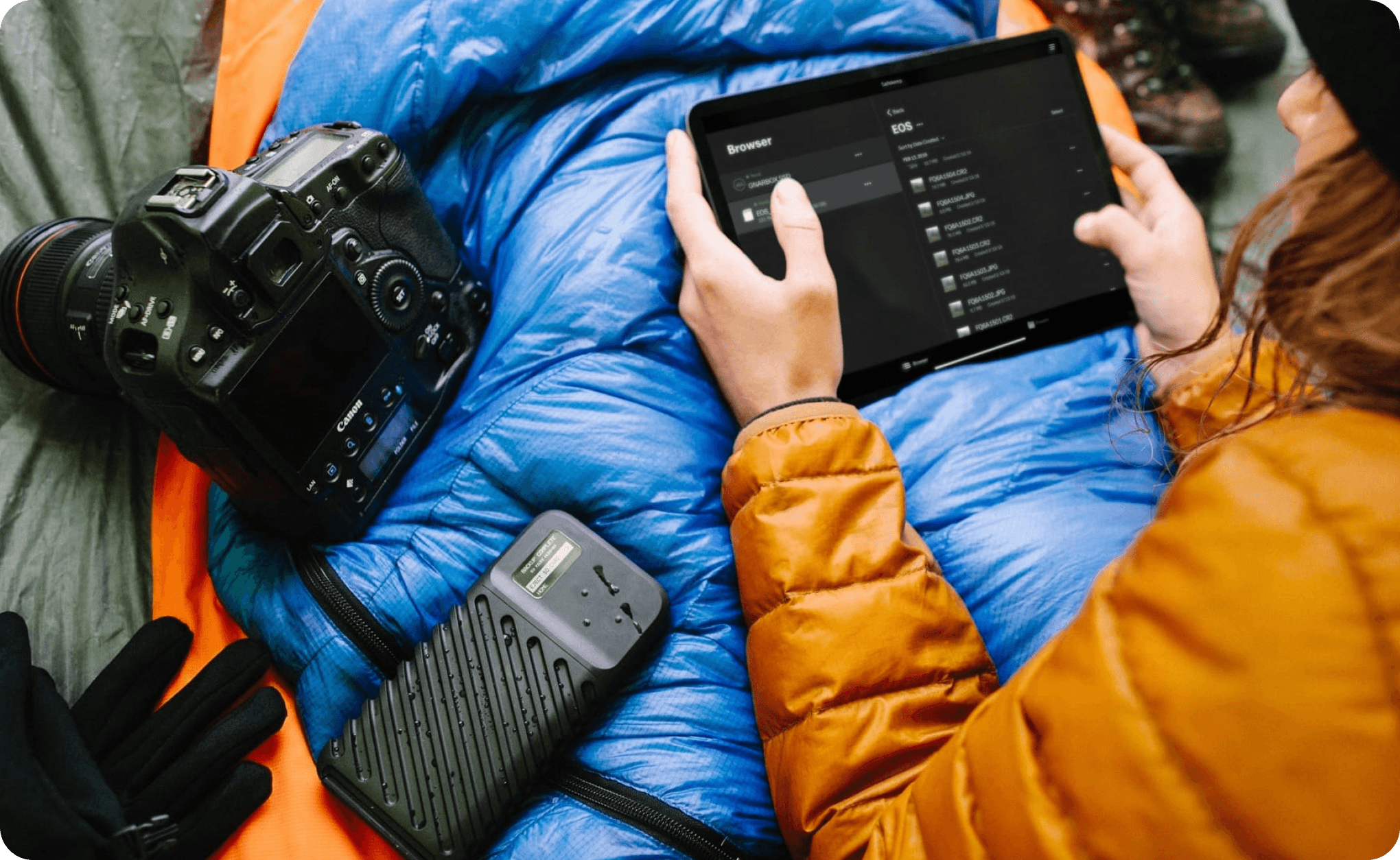 A photographer using the GNARBOX workflow in the field