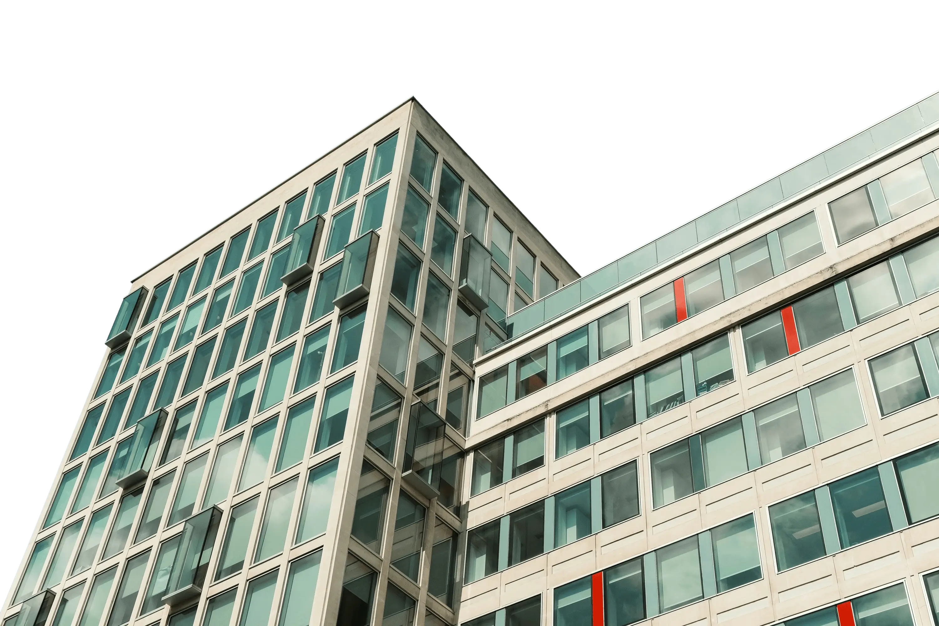 high-angle view of a modern glass office building against a clear blue sky