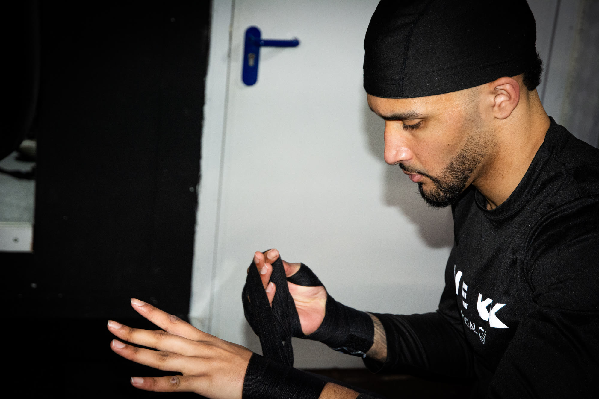 Samba from MEKK Barbershop Applying Boxing Handwraps.