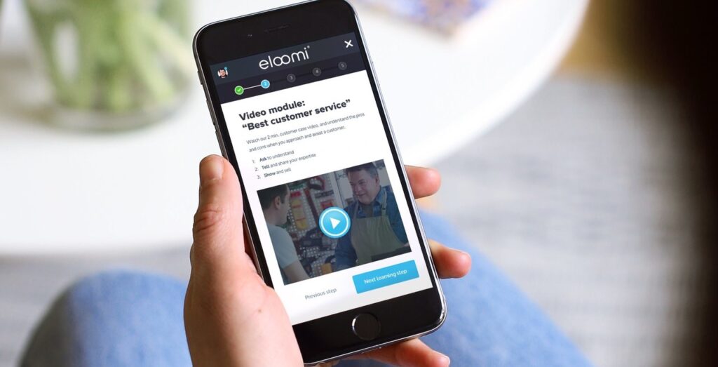 Mobile training app eloomi showing customer service learning video