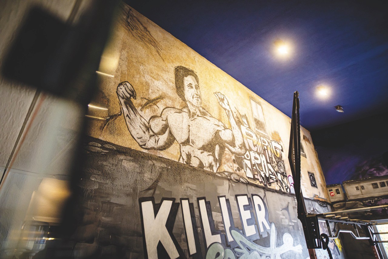 Modern house exterior with a pool and outdoor dining area.