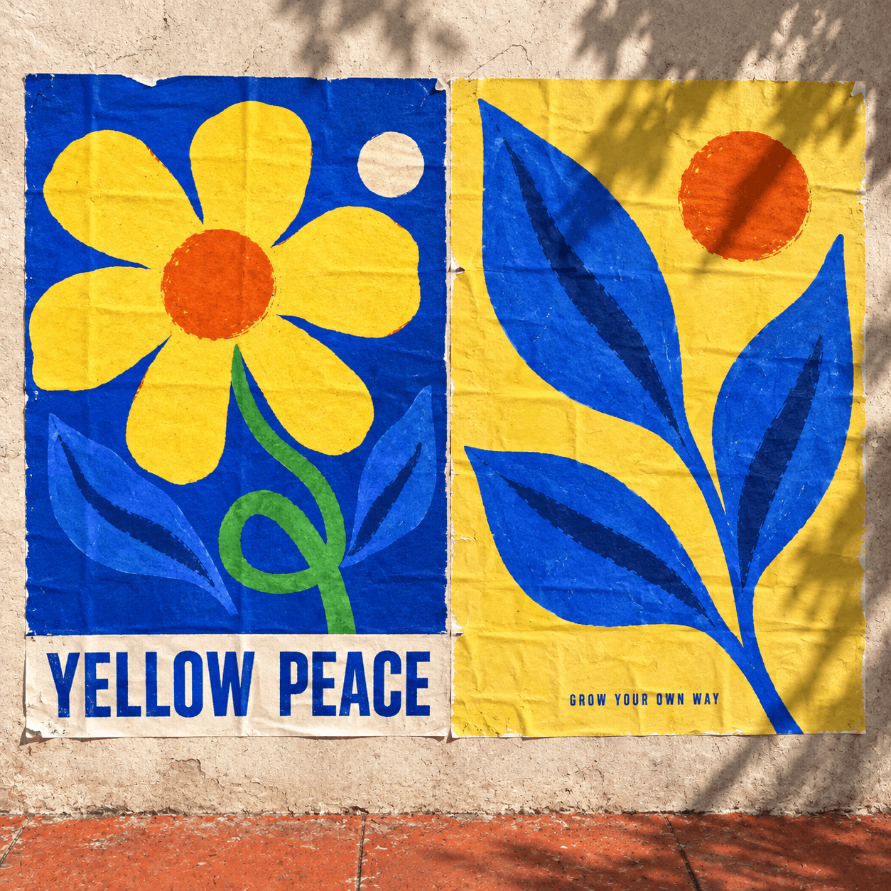 Yellow Peace flower posters in yellow and cobalt blue on a sunlit wall.