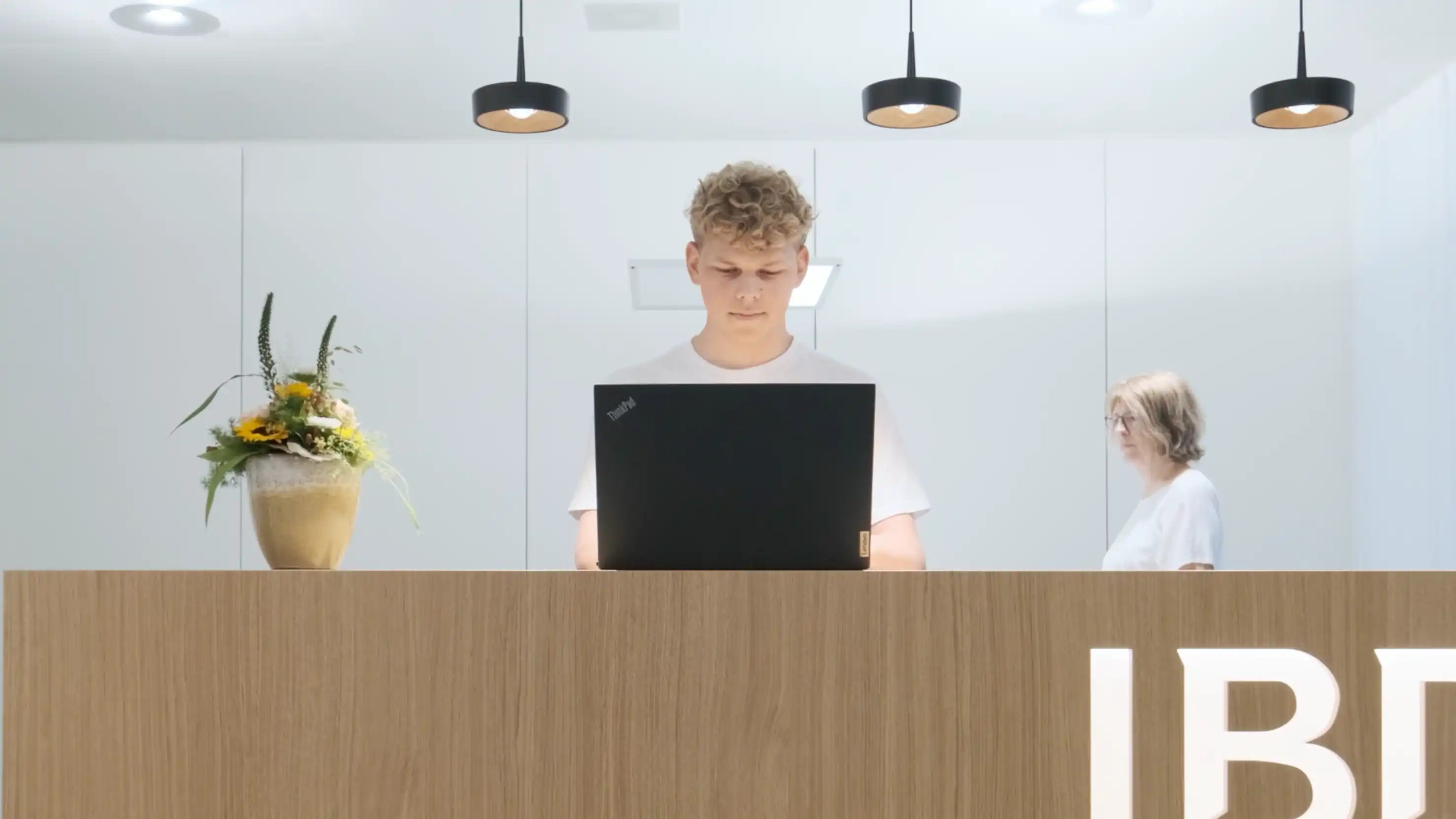 Image of a young men working behind a standing desk