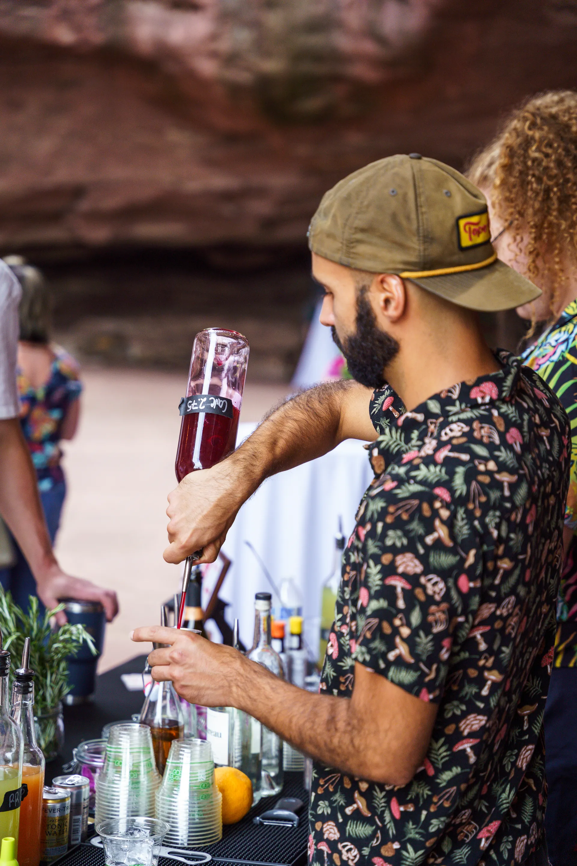 Alex pouring a cocktail from a bottle