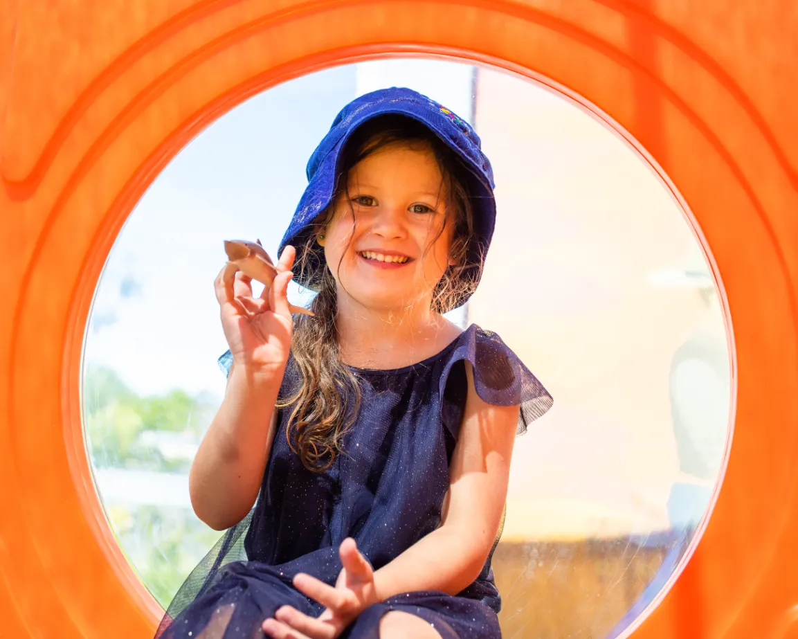 Toddler playing with a toy telephone during indoor learning time at Kaleidoscope Kids Redbank childcare centre.