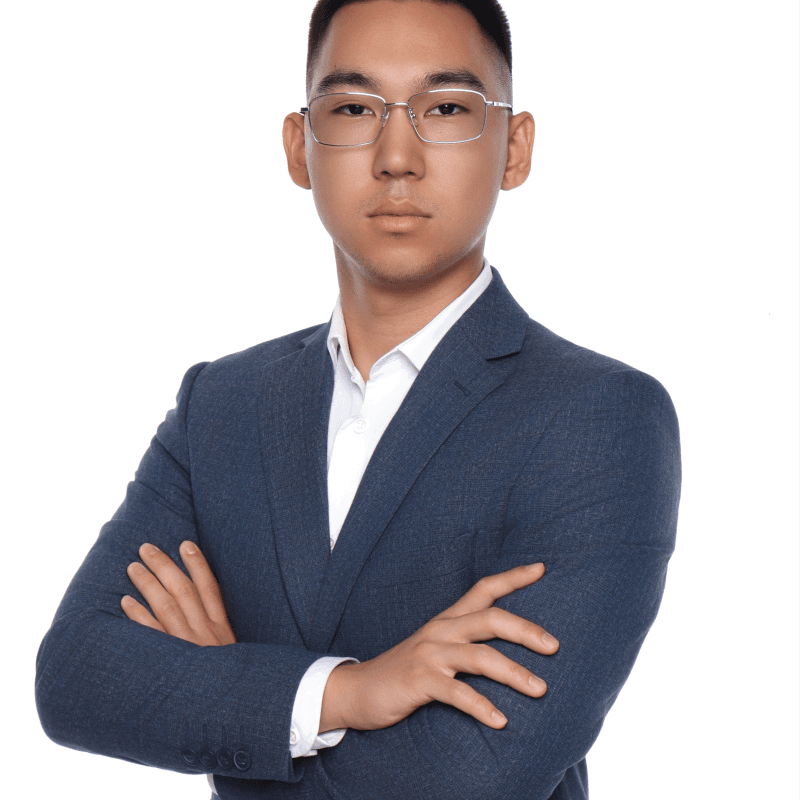 A woman with straight blonde hair wearing a light colored sweater looks away.