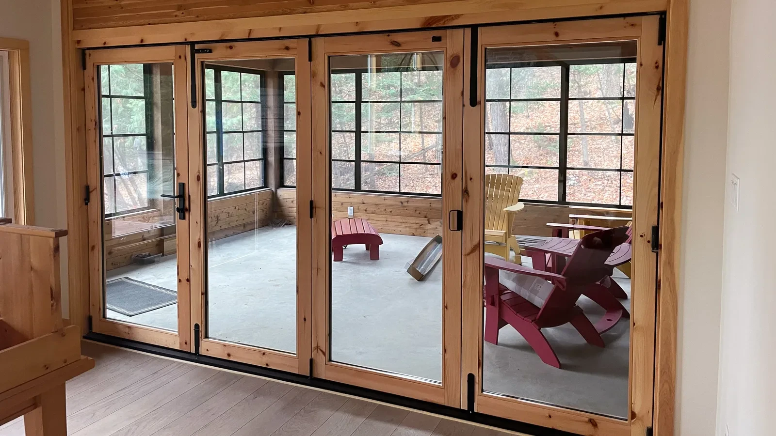 Three season sun room with rustic accordian doors Canning Lake Haliburton Ontario.
