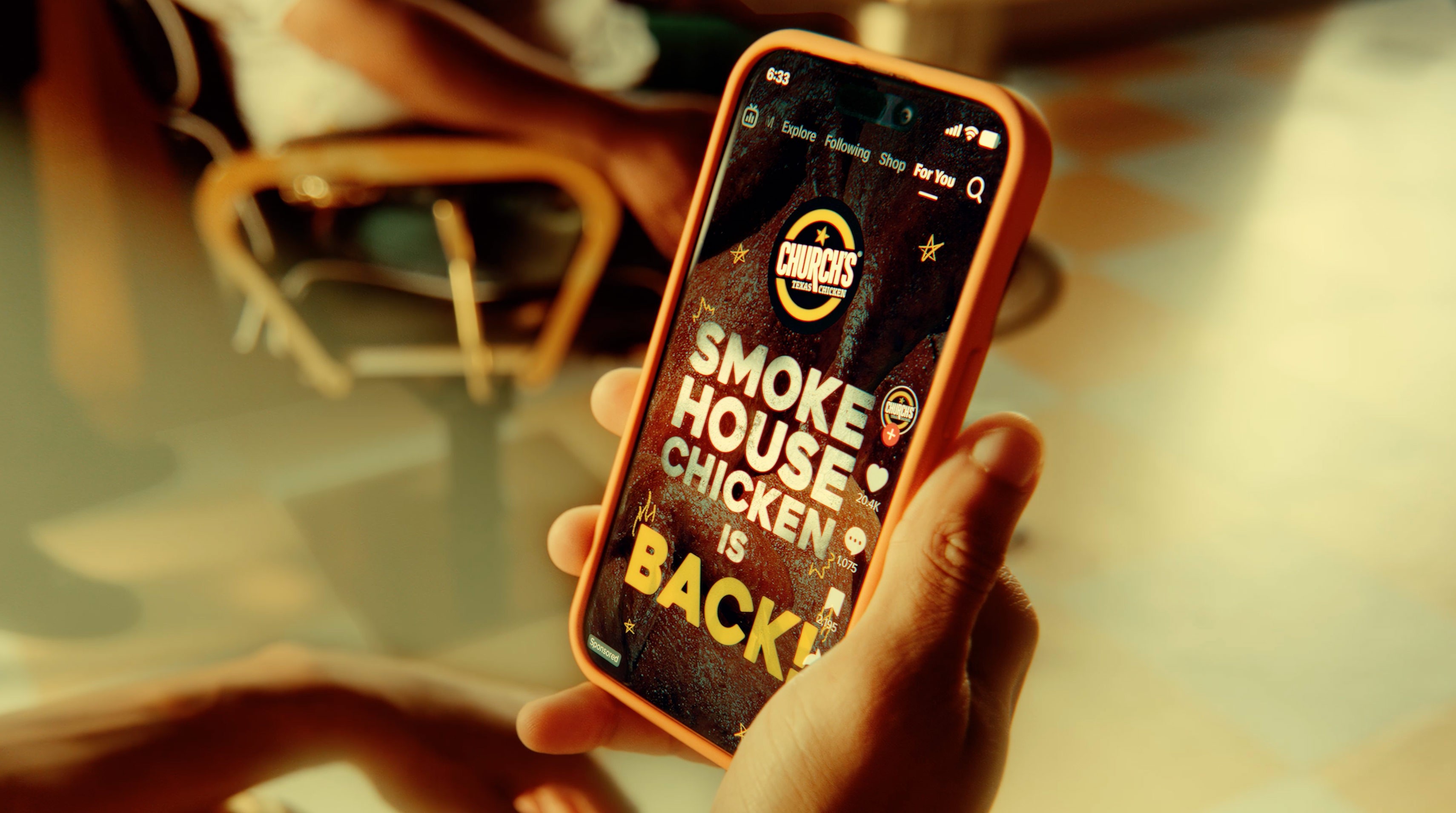 White branded cap with turquoise logo placed on fresh lemons in a red bowl