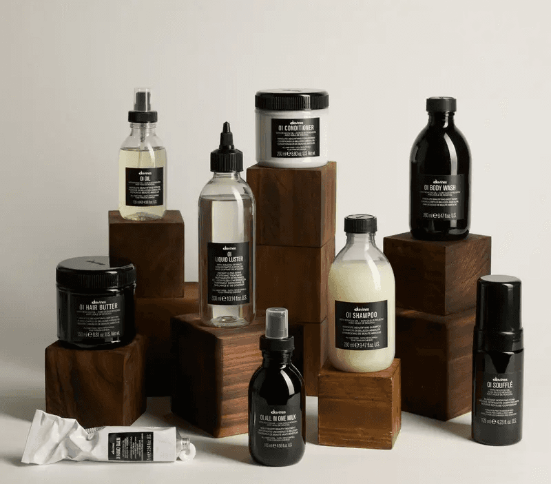 Davines OI hair care product collection including shampoo, conditioner, oil, and treatment