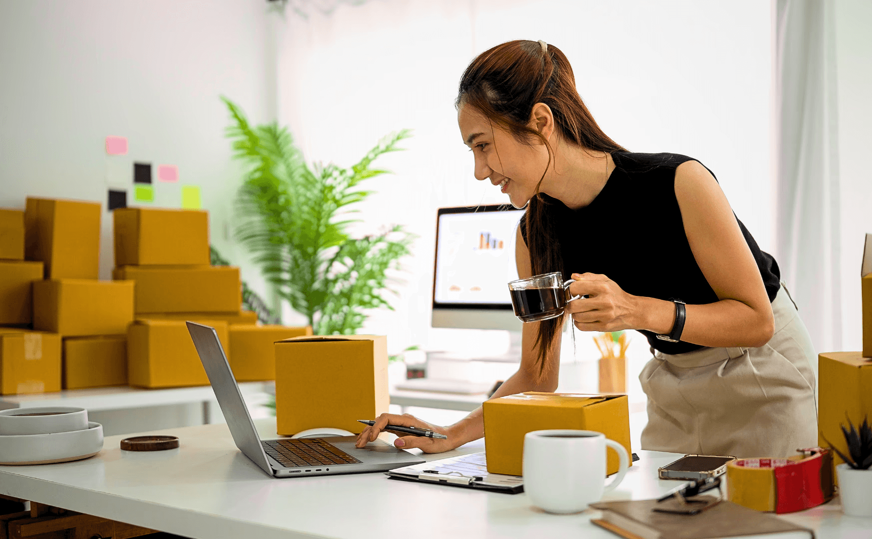 Asian girl working while having a coffe