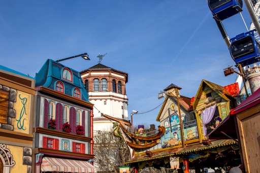 A maroon passport, a credit card, and a document are placed on a dark surface.
