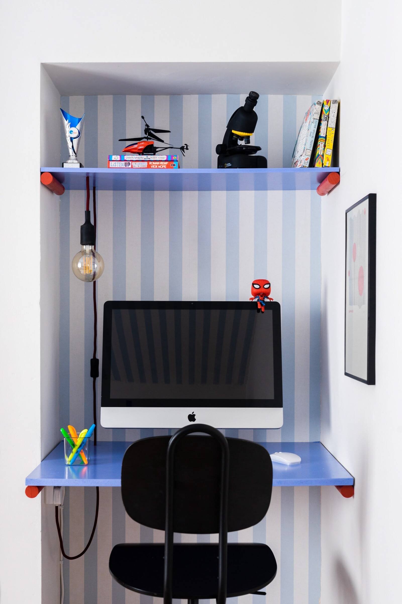 Custom desk with computer and small decorative toys for a small nook in a playful, contemporary teenager’s room renovation by interior design studio Atelier Akuko.