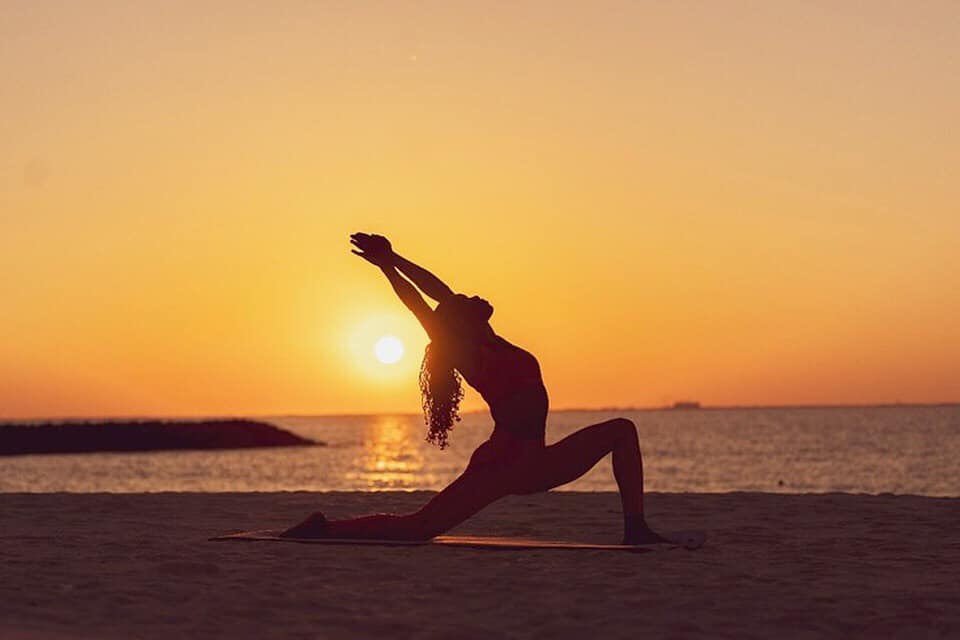 Black-and-white party photo of a smiling man in a check blazer among a crowd.