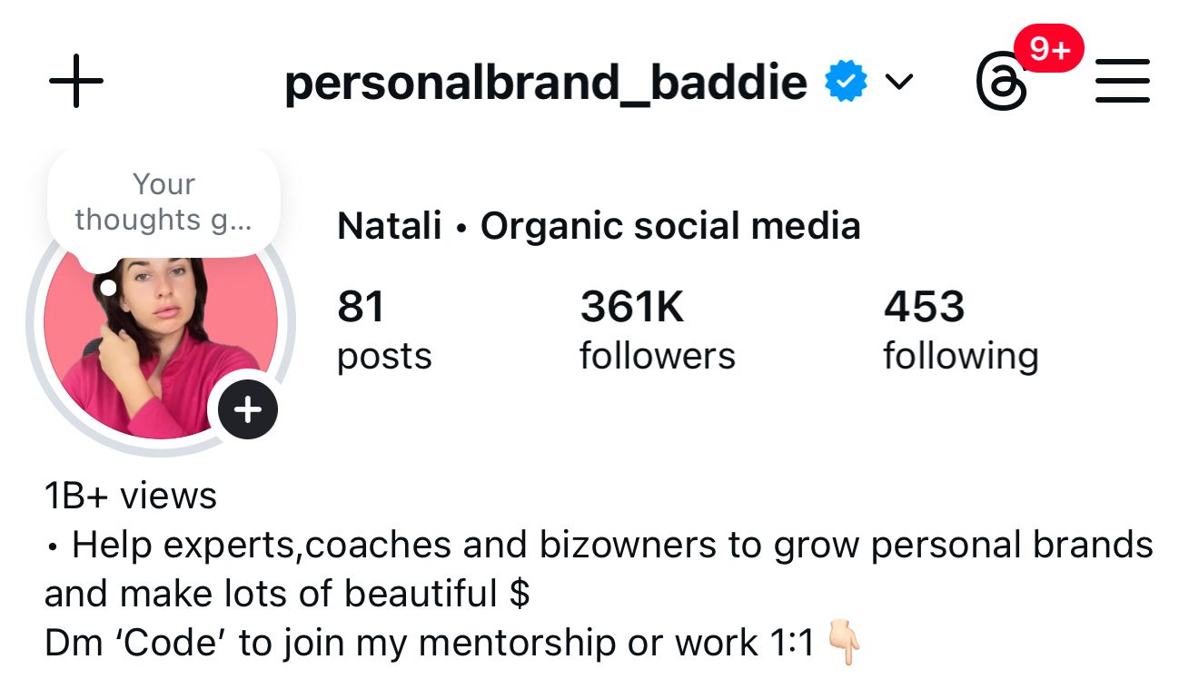 black DSLR camera floating over man's hand at the woods