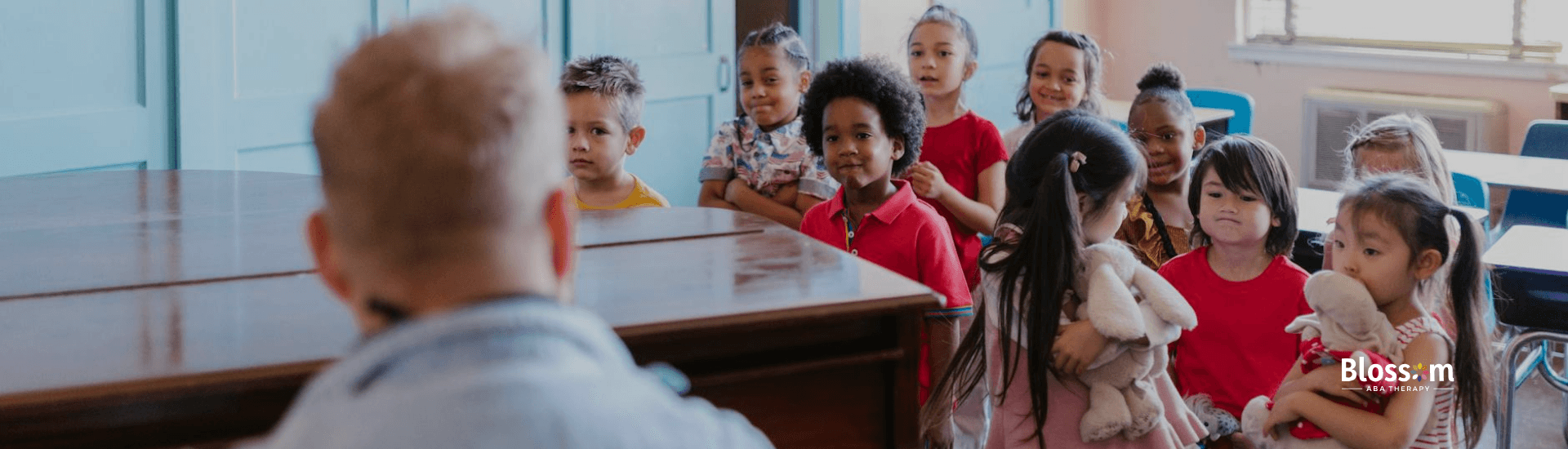 Autistic children during ABA therapy standing by a piano, listening to ABA therapist in Tennessee.