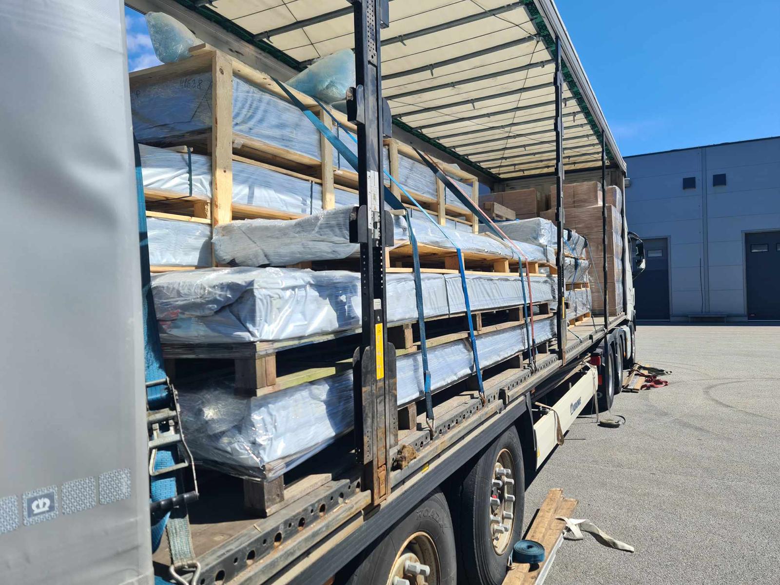 Close-up of a trailer loaded with strapped, wrapped groupage cargo