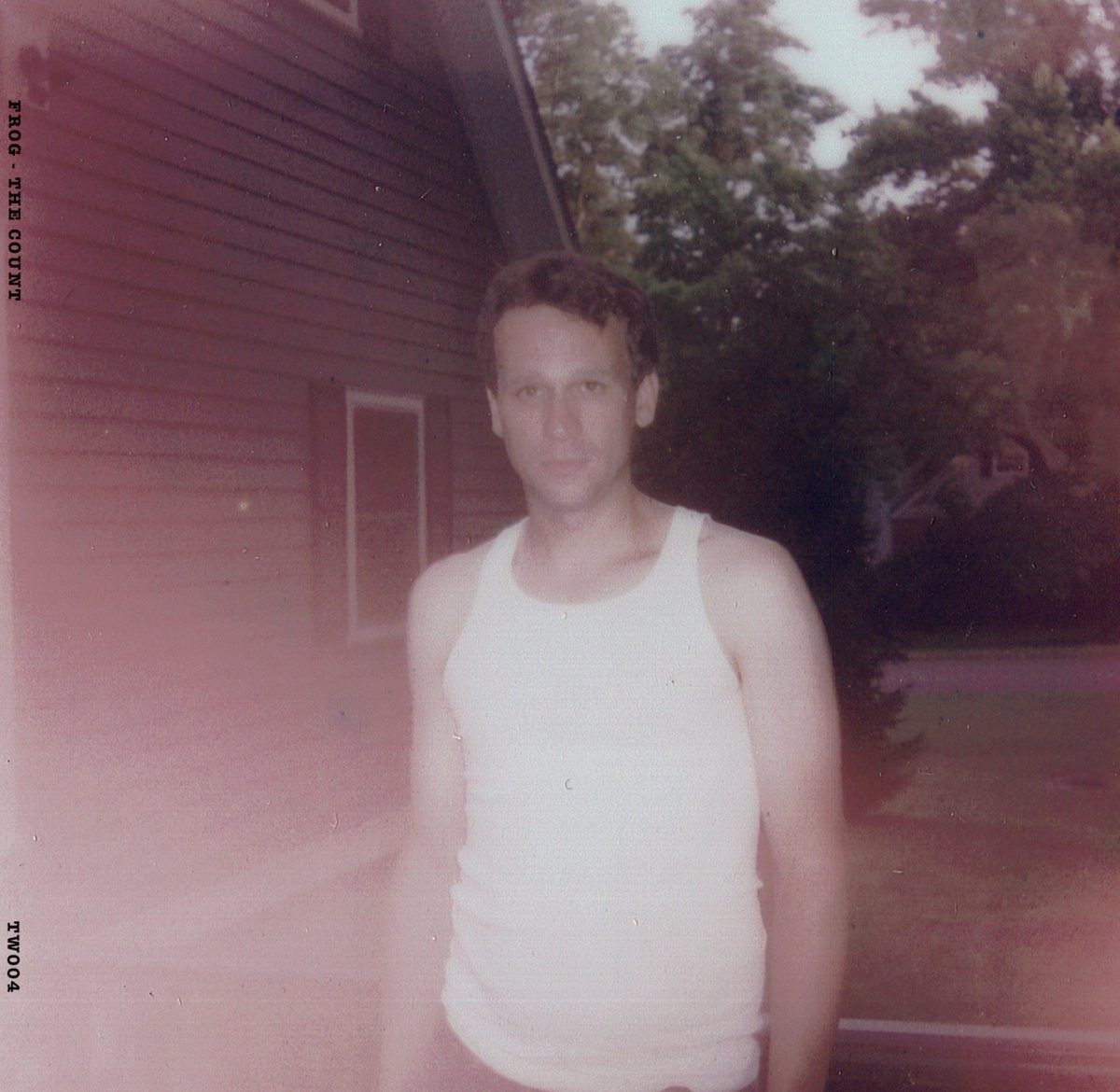 THE COUNT album cover featuring Daniel Bateman in a white tank-top staring blankly at the camera.