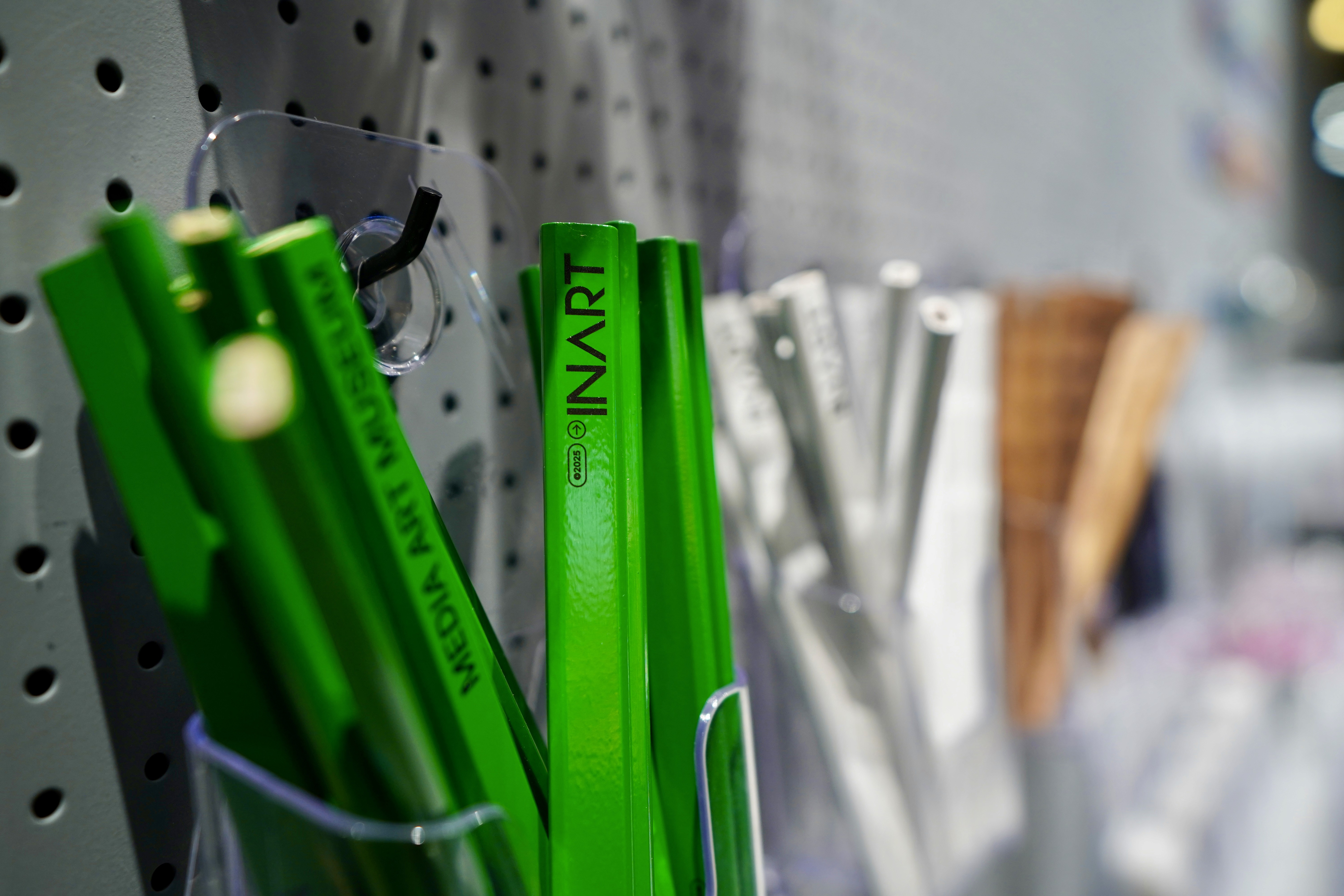 a wooden table topped with lots of books and pencils