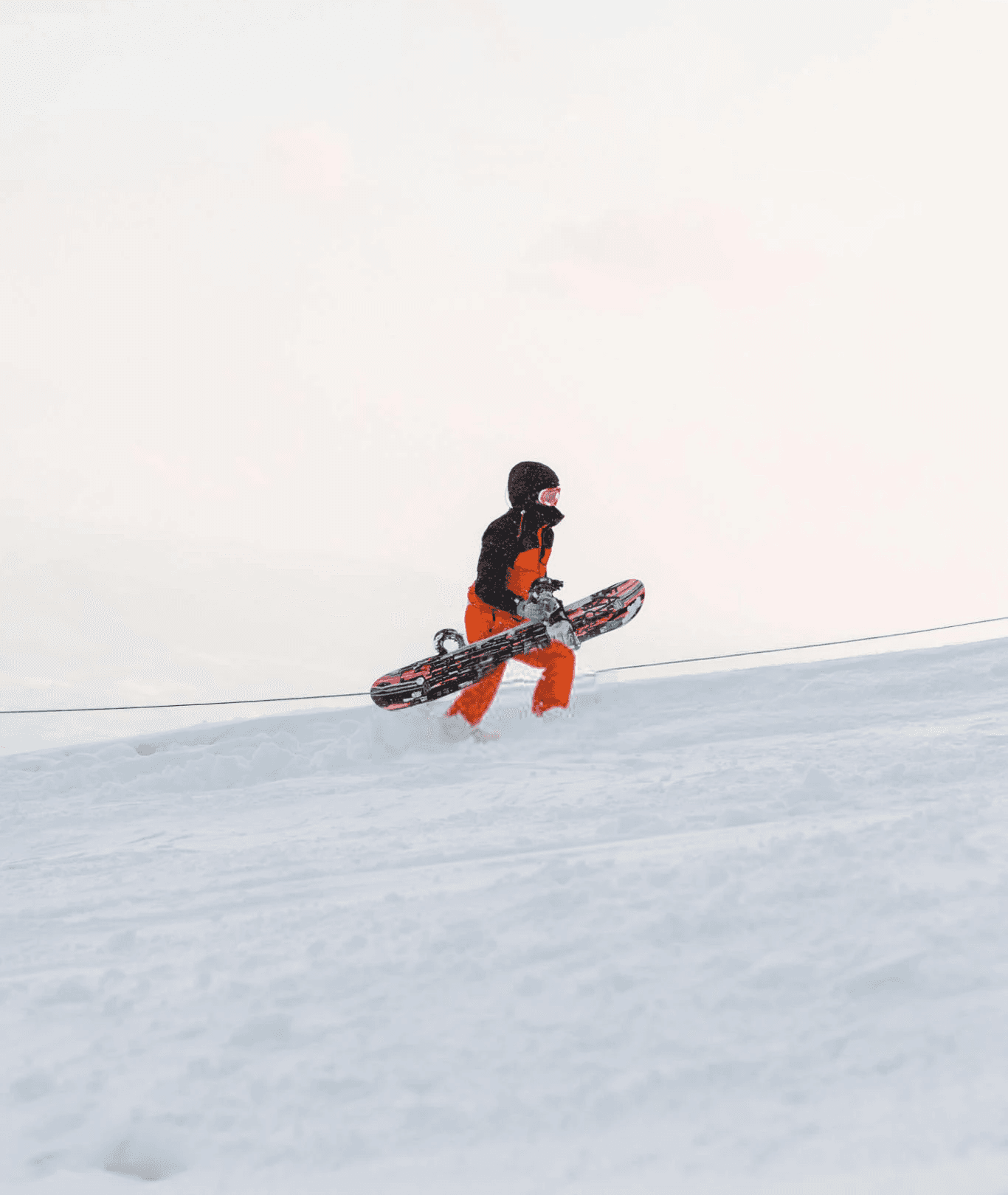 A close-up of a pink cocktail in a martini glass, set against a nighttime background with soft, blurred colors.