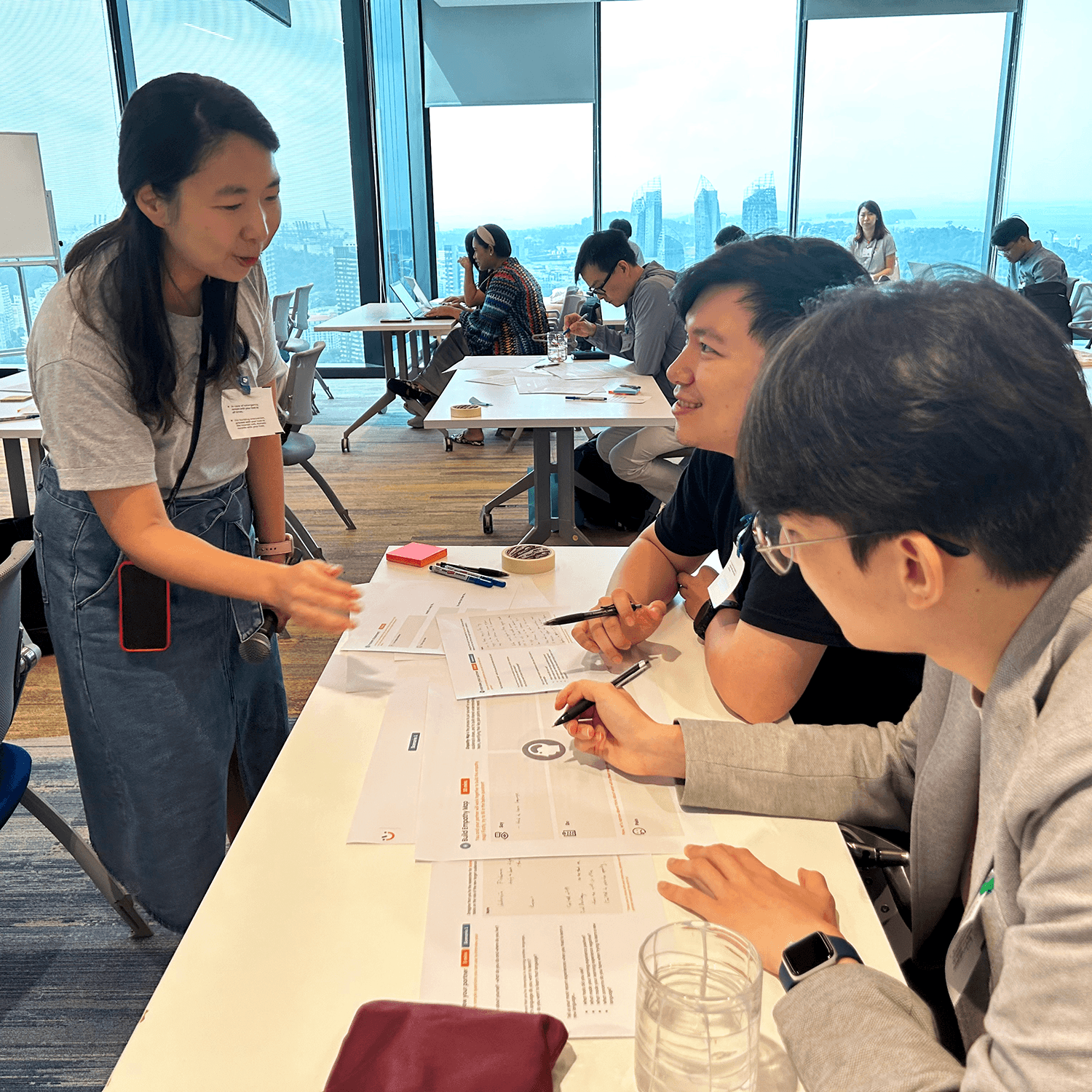 Two participants in discussion with a 55 Minutes facilitator