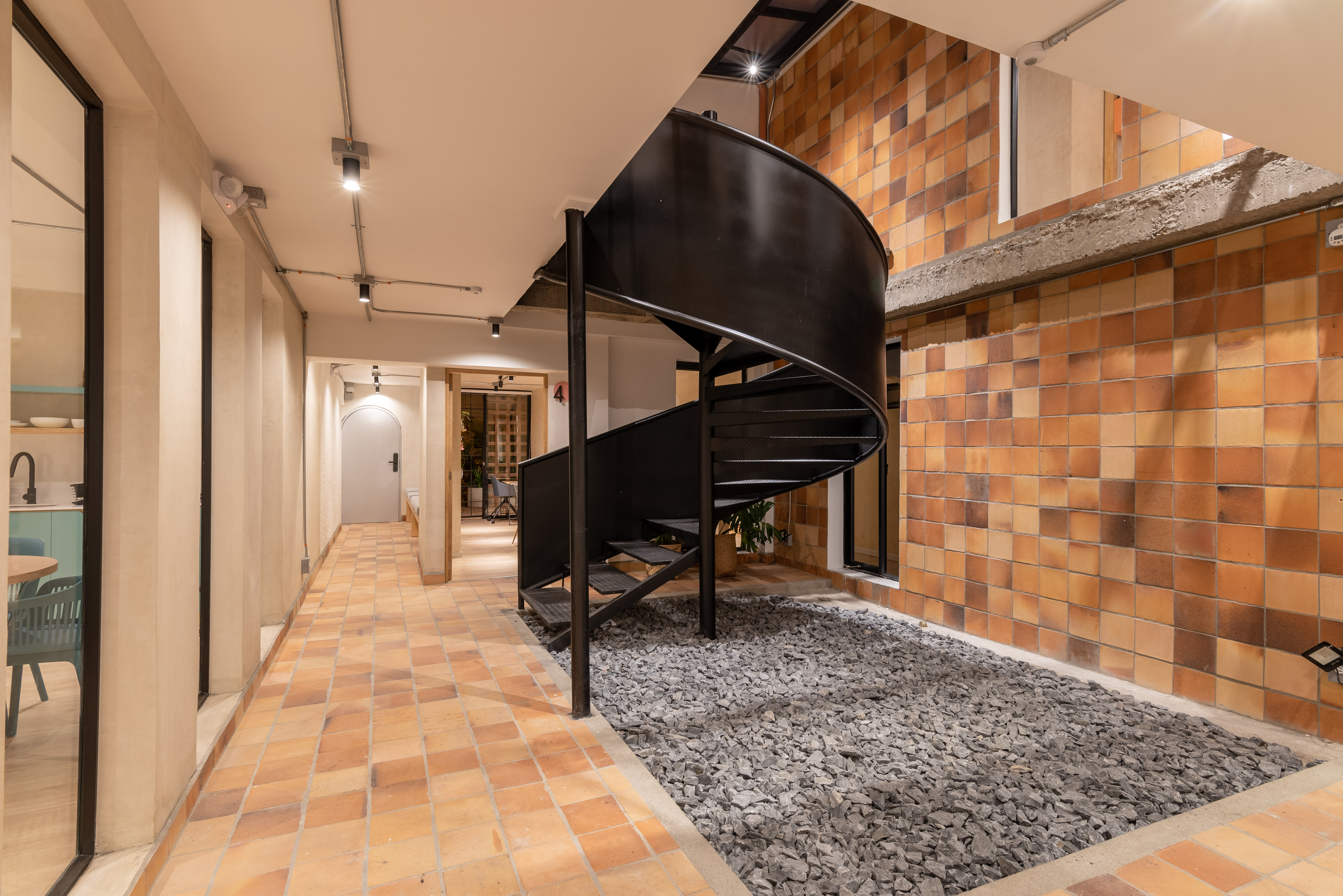 Double-height interior with flowing sculptural forms and warm raking light