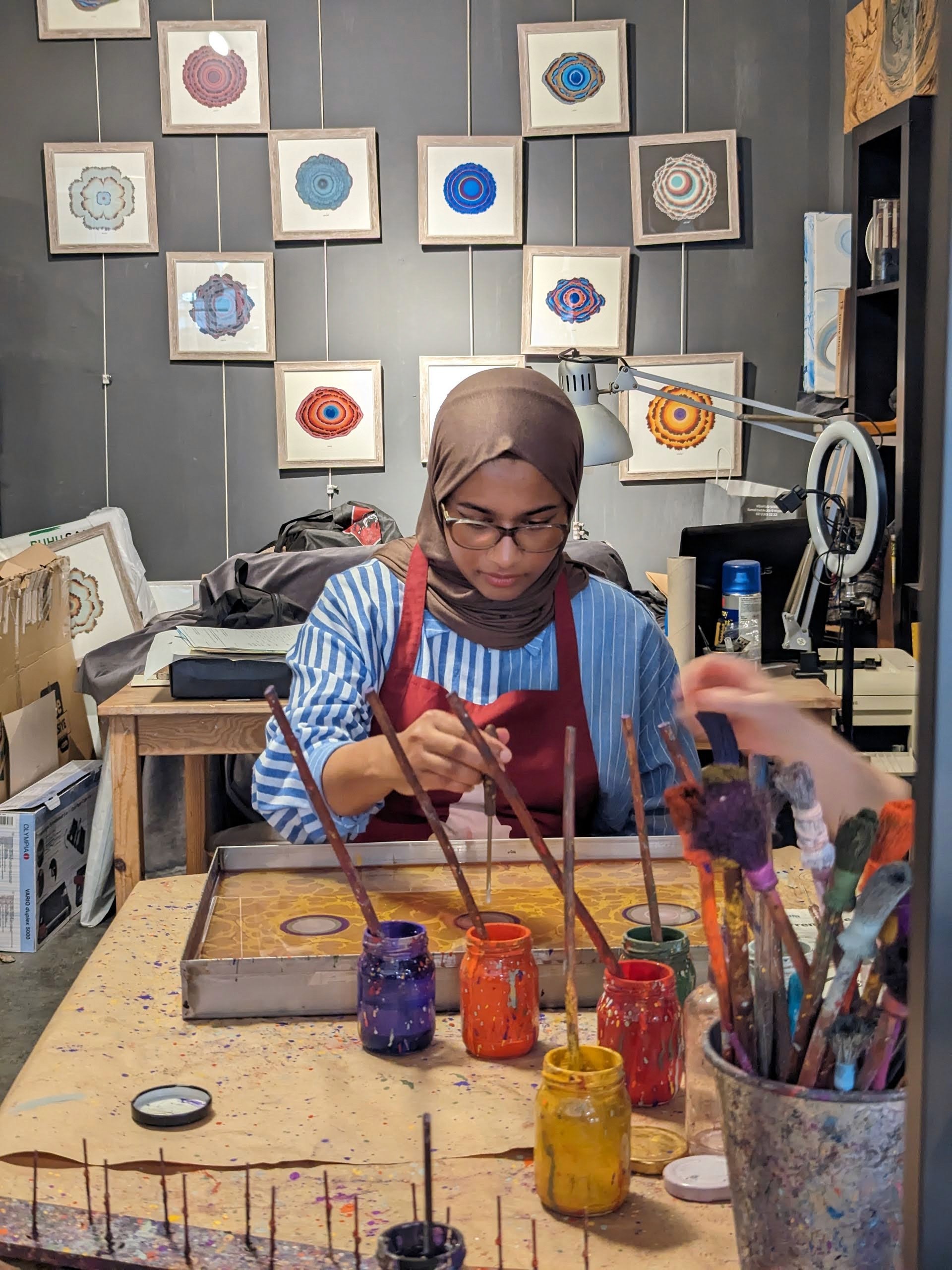 me holding a paintbrush water-marbling