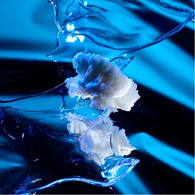 Cosmetic texture ingredient in fluid form with blue lighting representing hydration and skincare formulation